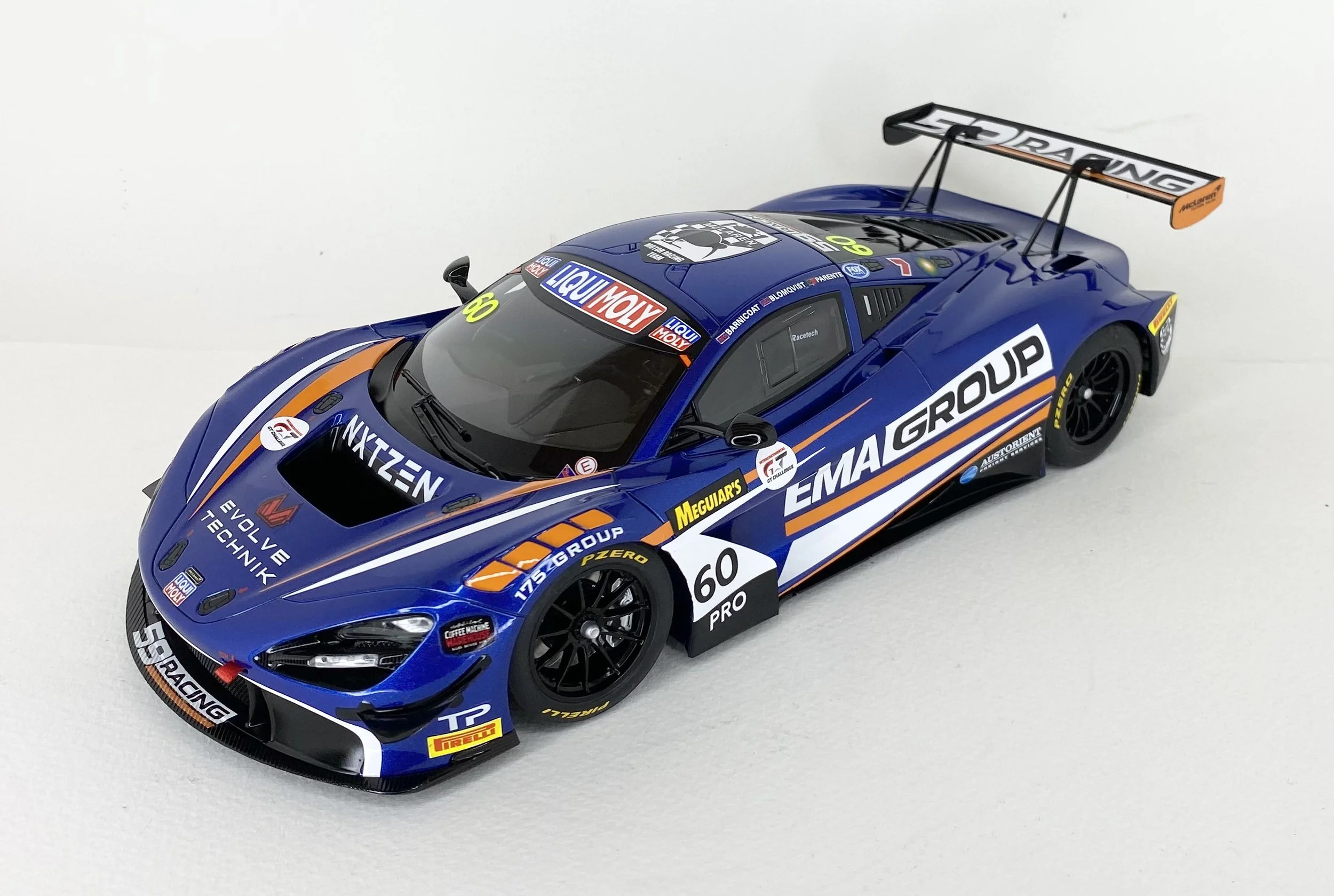 Scale model of a blue race car with sponsorship decals and the number 60 on the side.