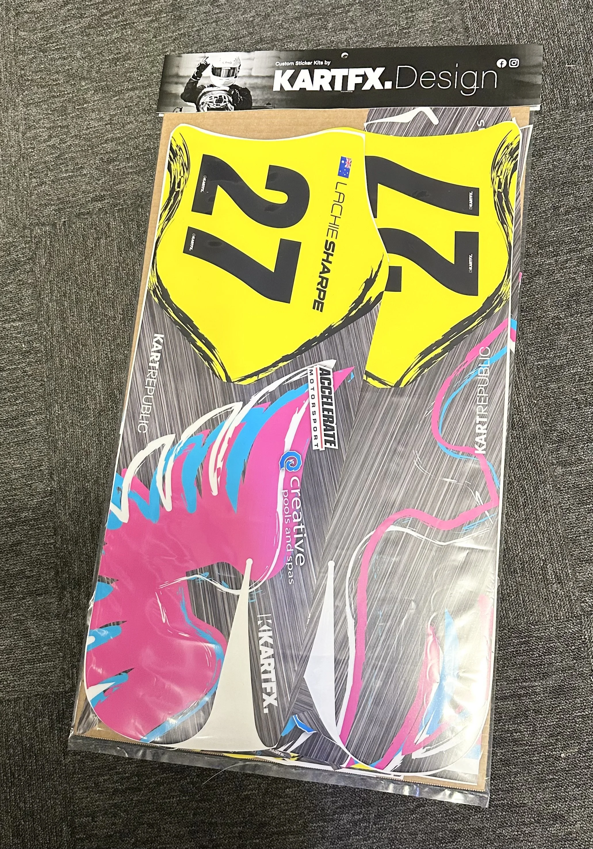 Colorful motocross number plate stickers, primarily yellow with the numbers 22 in large black font, and advertising for KartFX Design and Kreativ Republic.