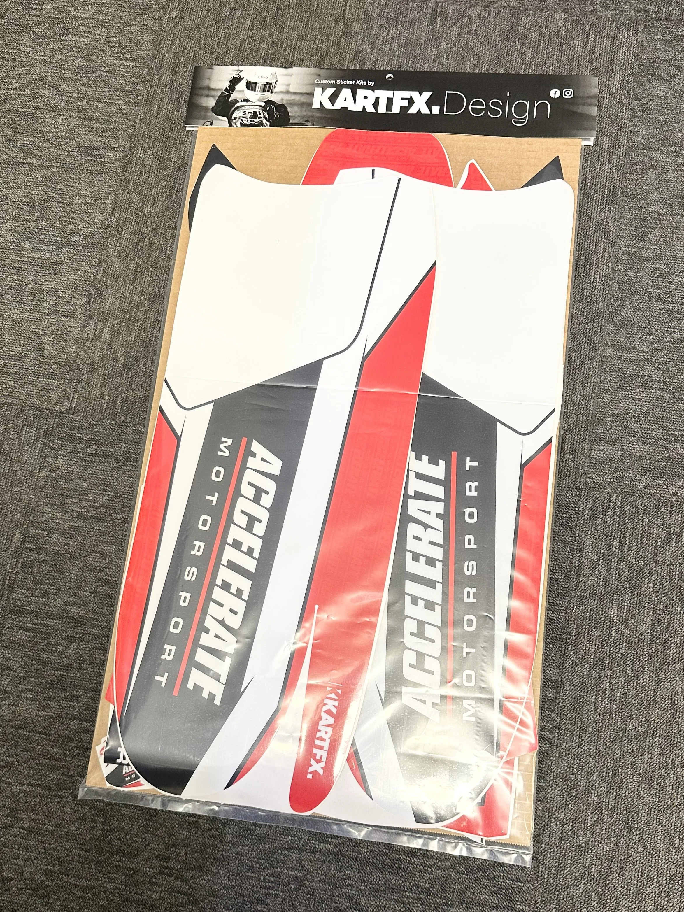 Motorcycle tank graphic sticker sheet labeled 'ACELERATE' with red, black, and white design, in packaging from 'KARTFX Design'.