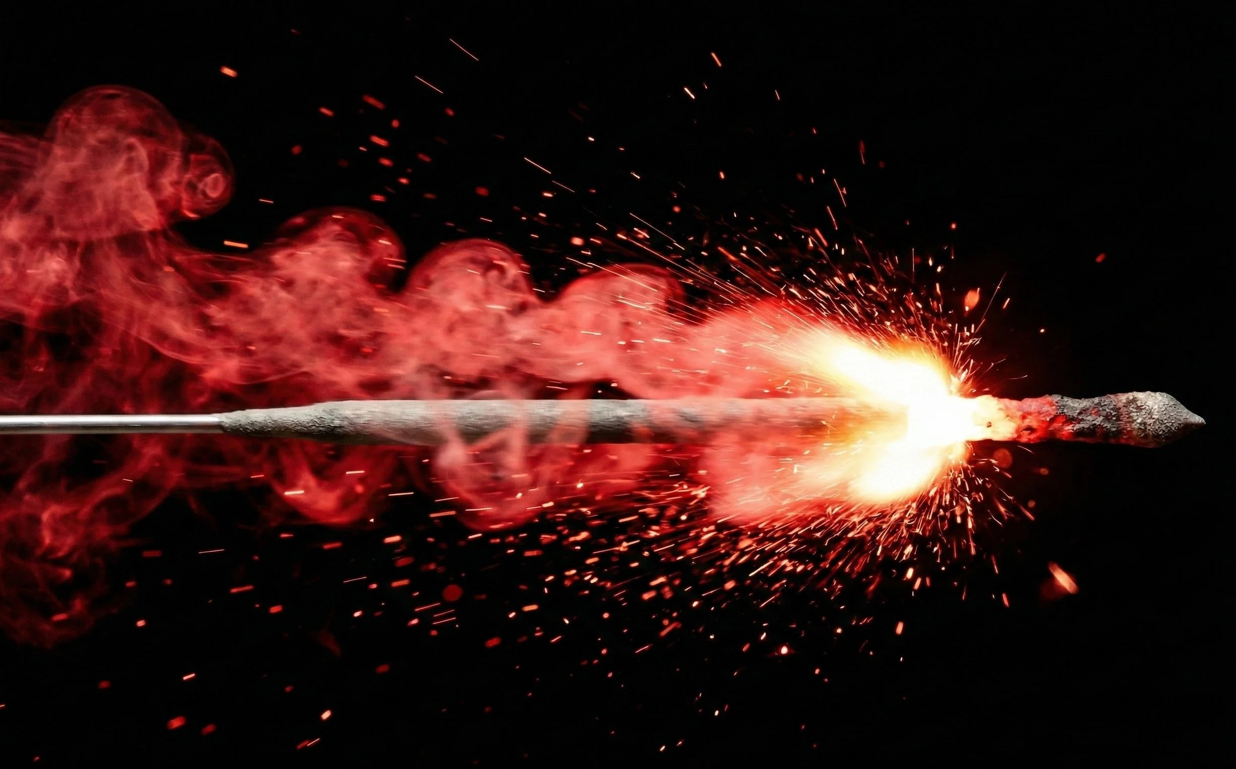 Lit match firing sparks and red smoke horizontally against dark background, representing the precision and momentum of Accendo Marketing's digital marketing execution for recruitment firms