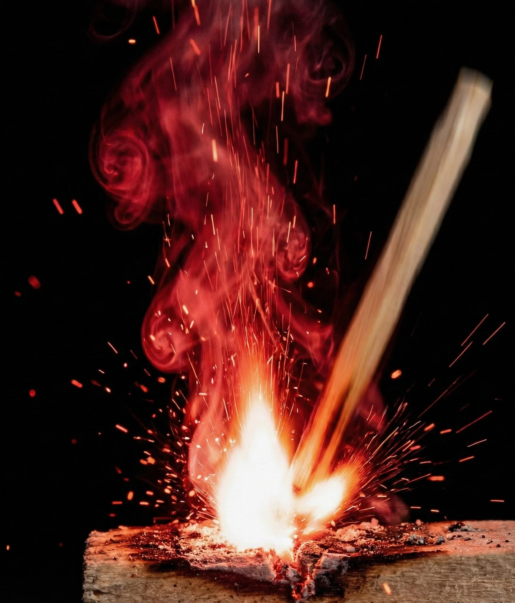 Close-up of match igniting with bright flame, red smoke and flying sparks, capturing the moment a recruitment marketing strategy comes to life with Accendo Marketing