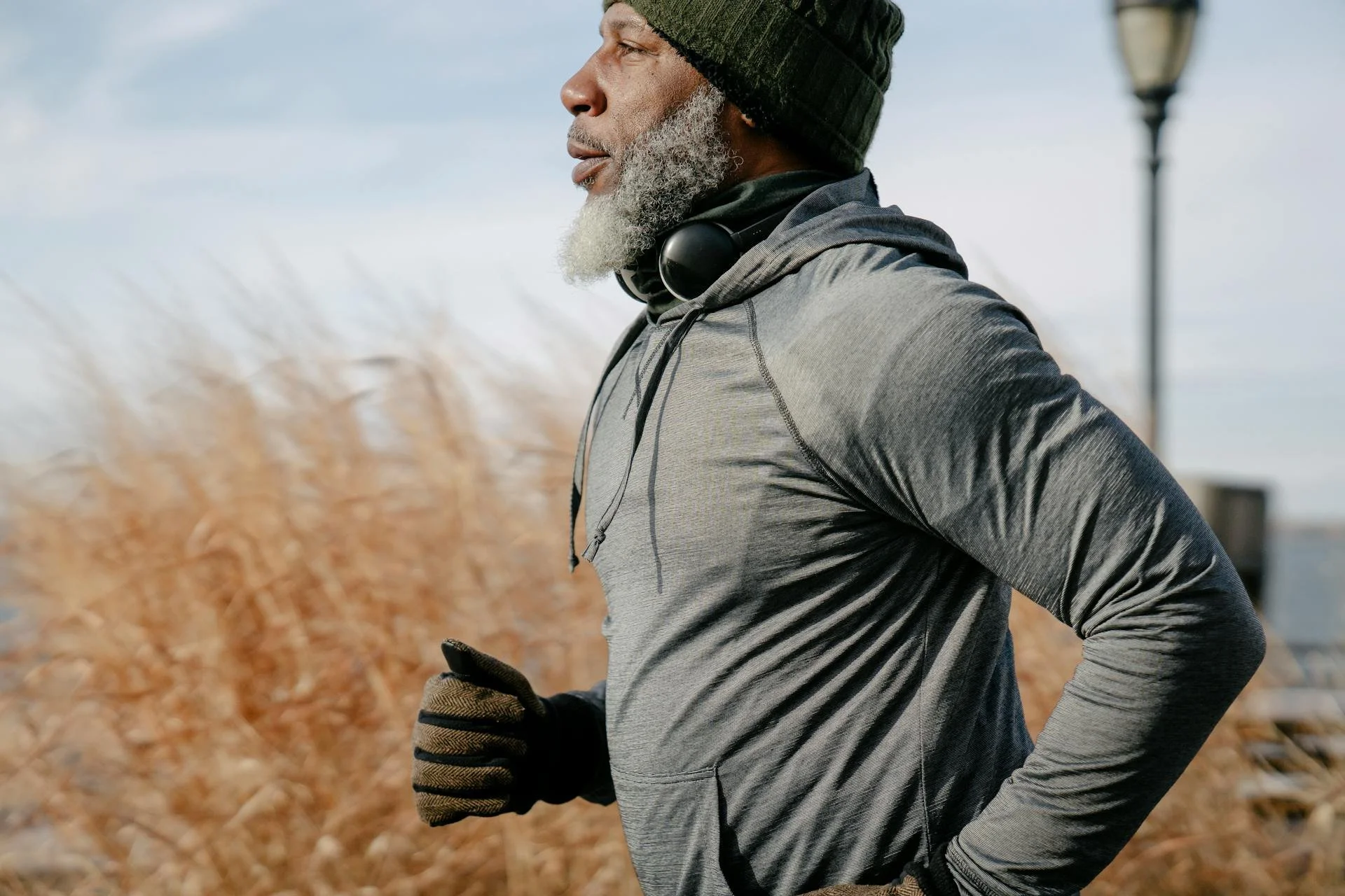 A middle-aged man running outdoors after receiving hormone optimization therapy at Victoria Men's Health Clinic.