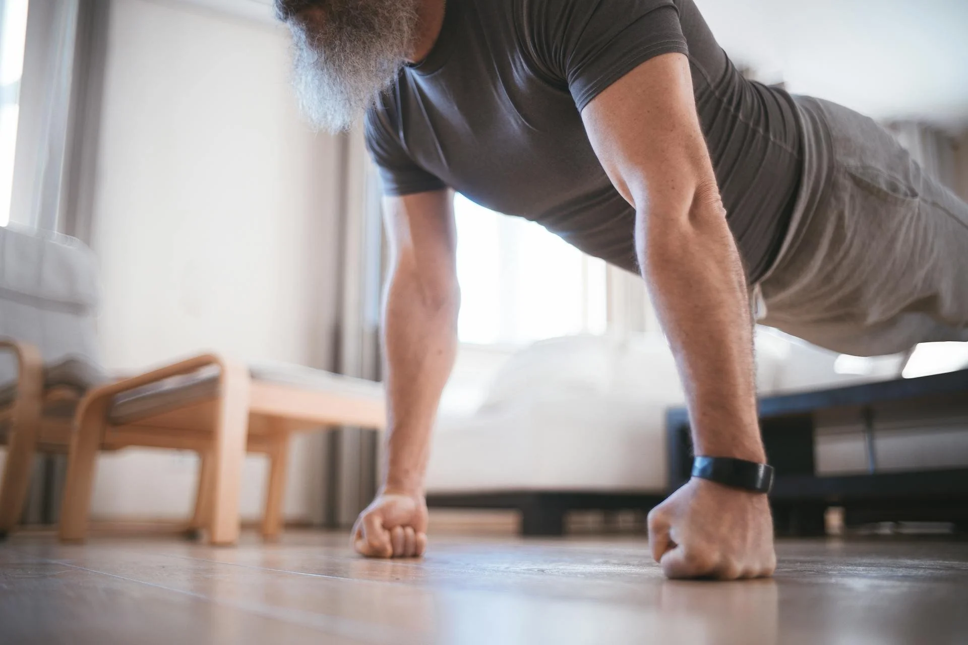 A senior man doing push ups thanks to longevity medicine treatments for men in Victoria, BC.