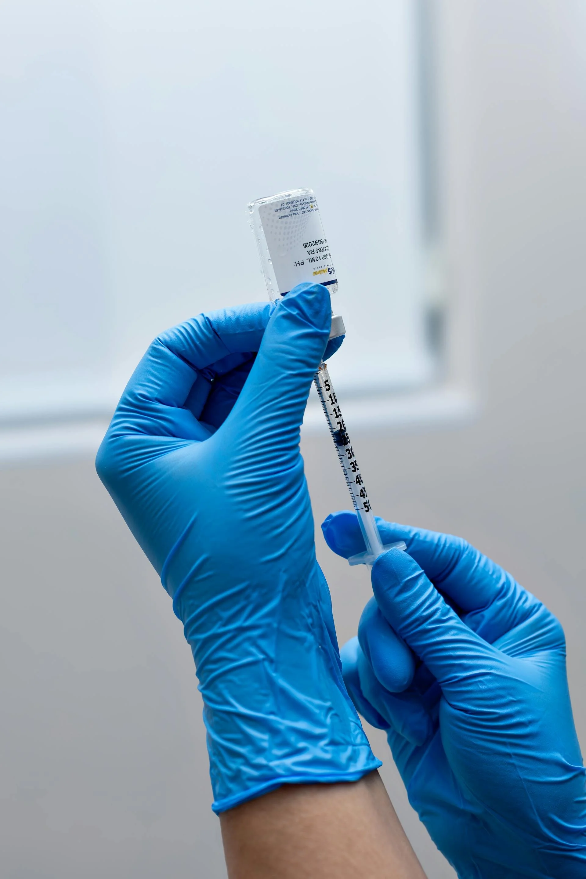 A syringe being prepared for botox for men in Victoria, BC.