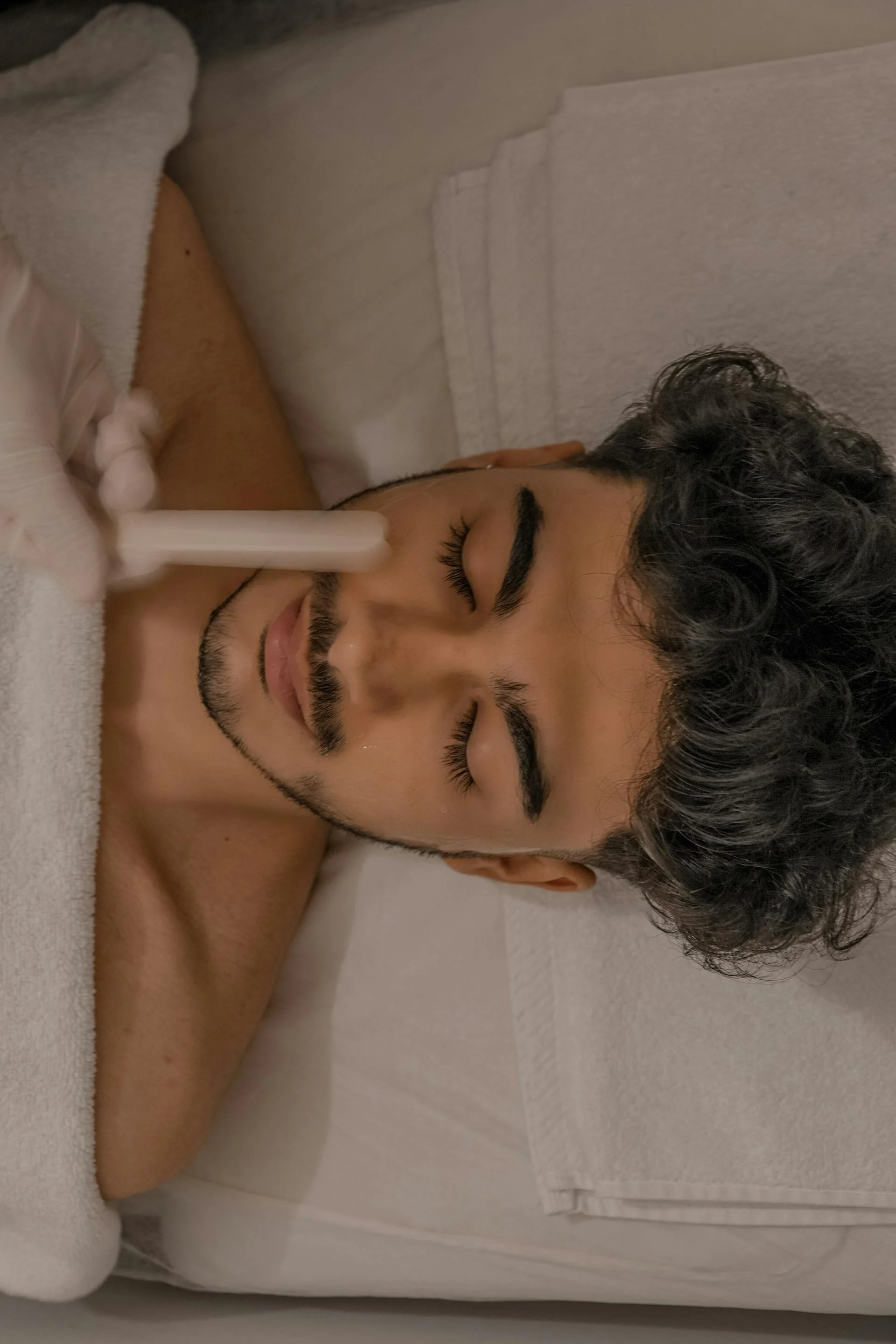 A man receiving cosmetic treatments for men at Victoria Men's Health Clinic.