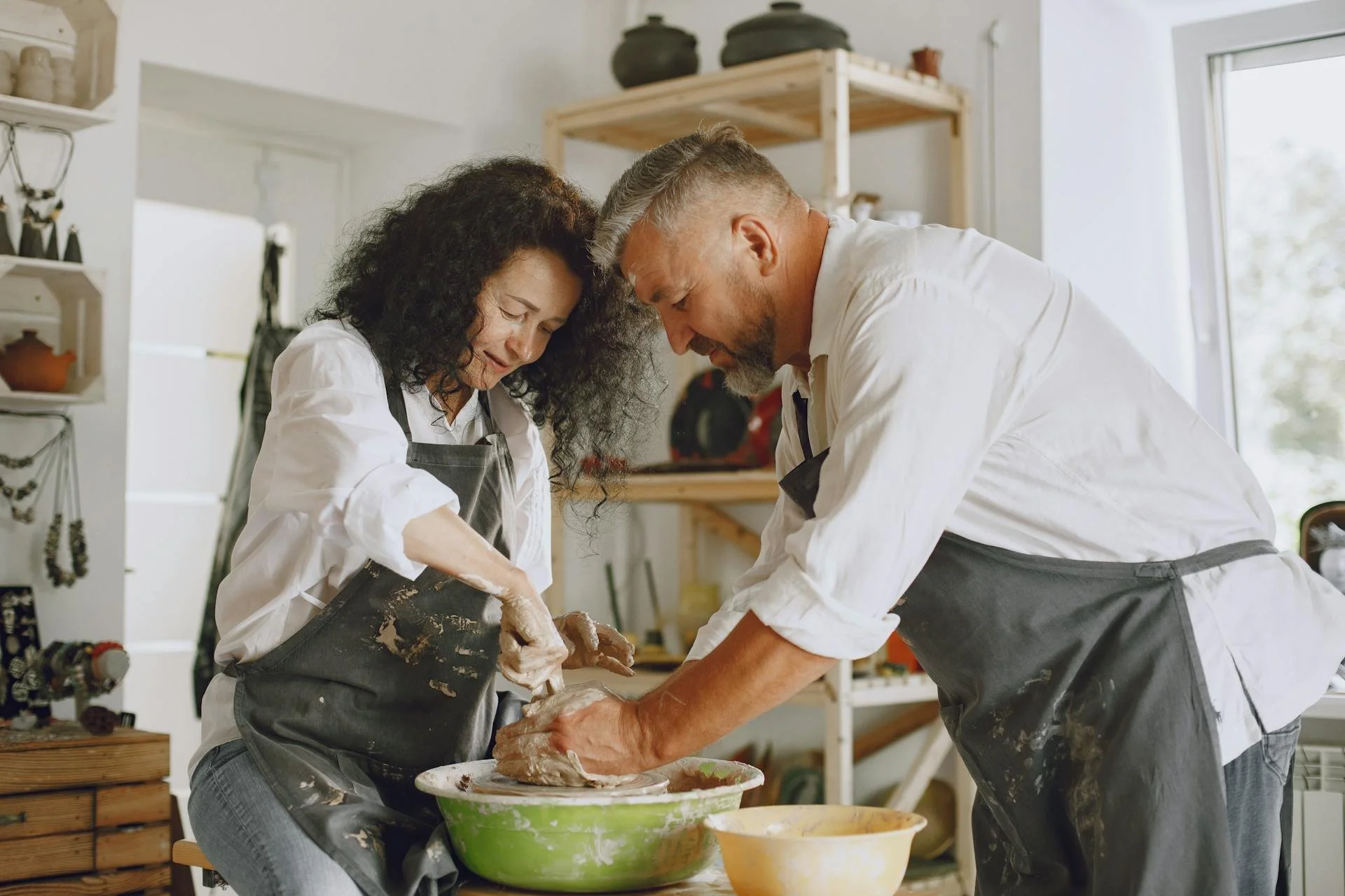 A middle-aged couple on a pottery date celebrating the decision to seek erectile dysfunction treatments at Victoria Men's Health Clinic.