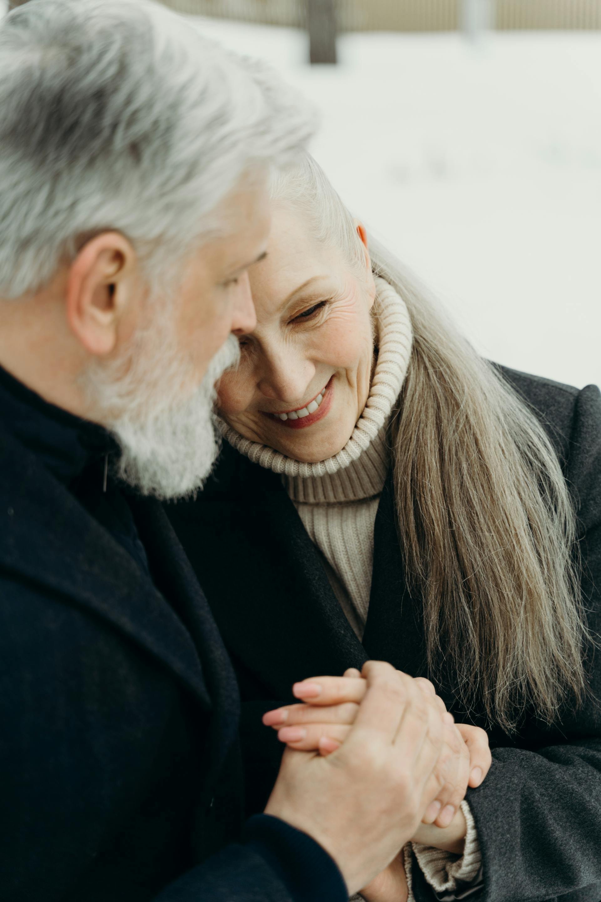 A senior couple cuddling outdoors after seeking erectile dysfunction treatment in Victoria, BC.