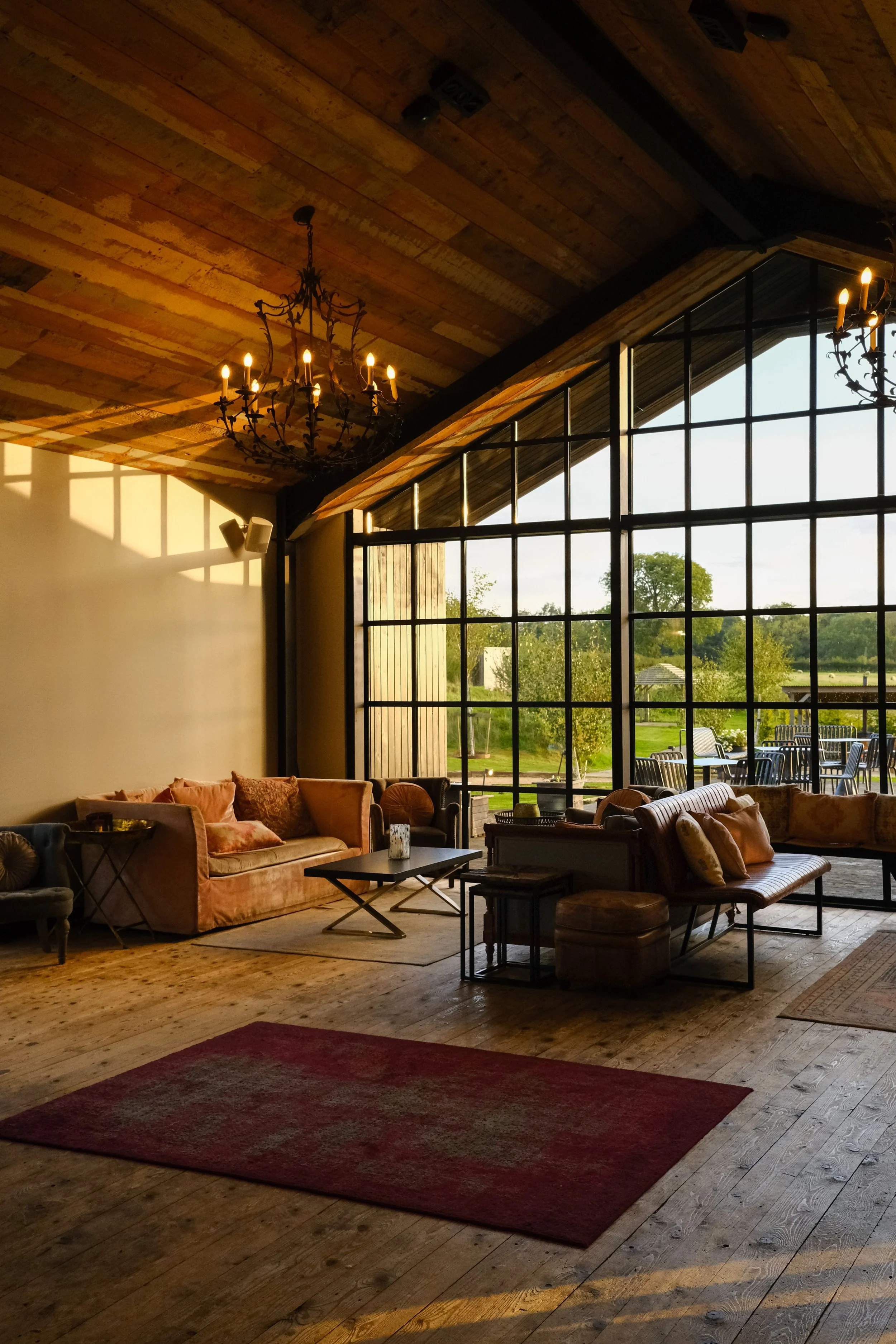 Sunset shining through the windows of a stylish and modern barn 