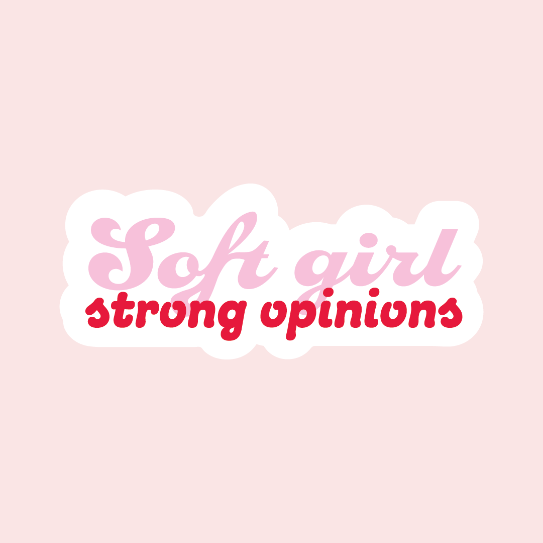 Tarra, jossa lukee isolla kaunokirjoituksella Soft girl ja sen alla pienellä tekstaus-kirjaimella punaisella strong opinions