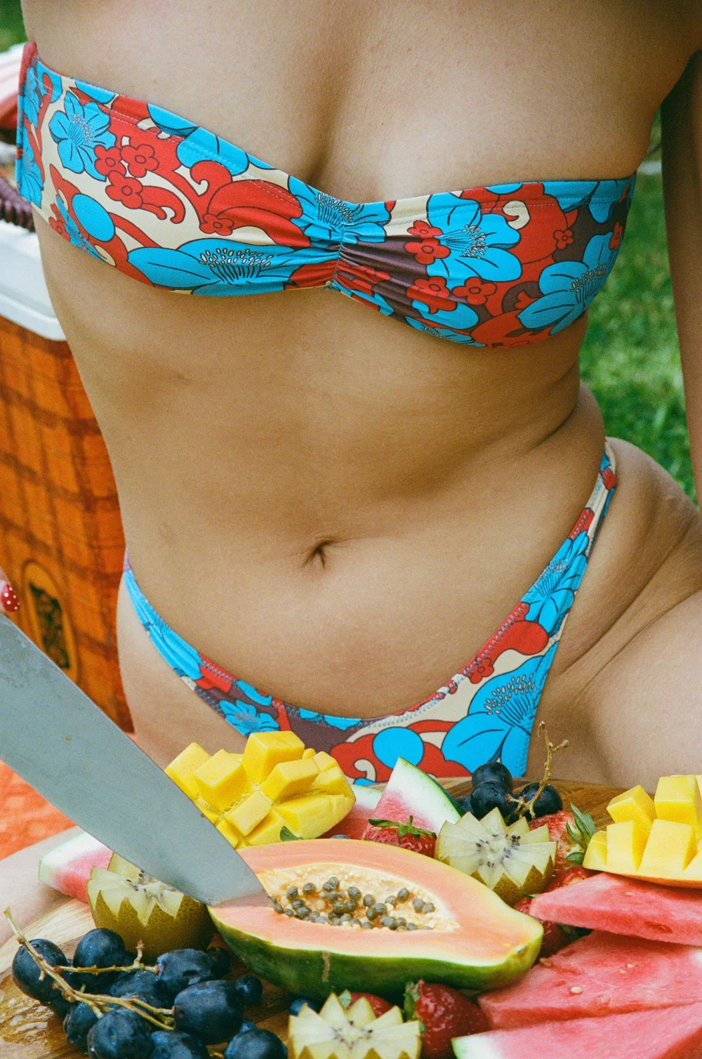 View of girl wearing Love Stoner Eva Ruched Bikini Top in Hibiscus Print