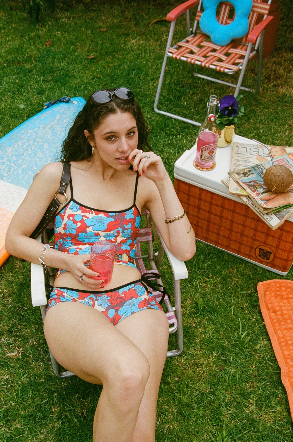 Girl wearing Love Stoner Lulu Shorties in Hibiscus print while sitting on chair