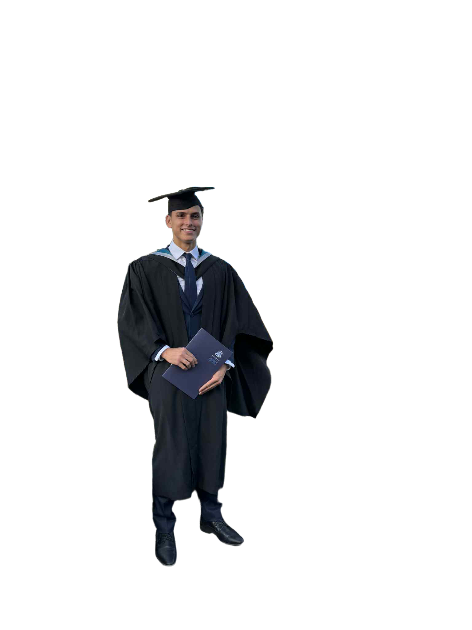 A young man wearing a black graduation gown and cap, holding a diploma, standing and smiling against a black background.