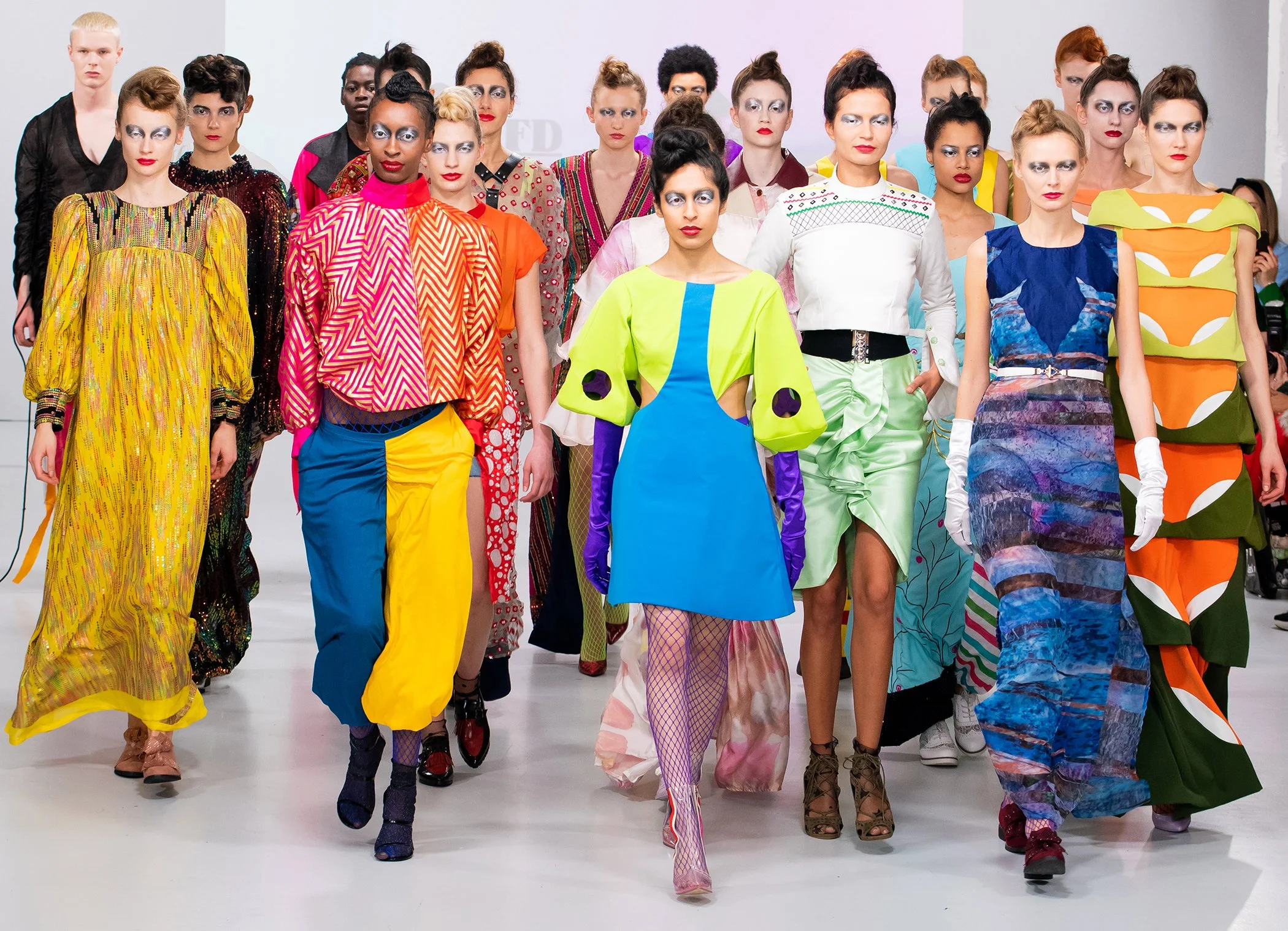 Models on the catwalk in a finale at a fashion week show