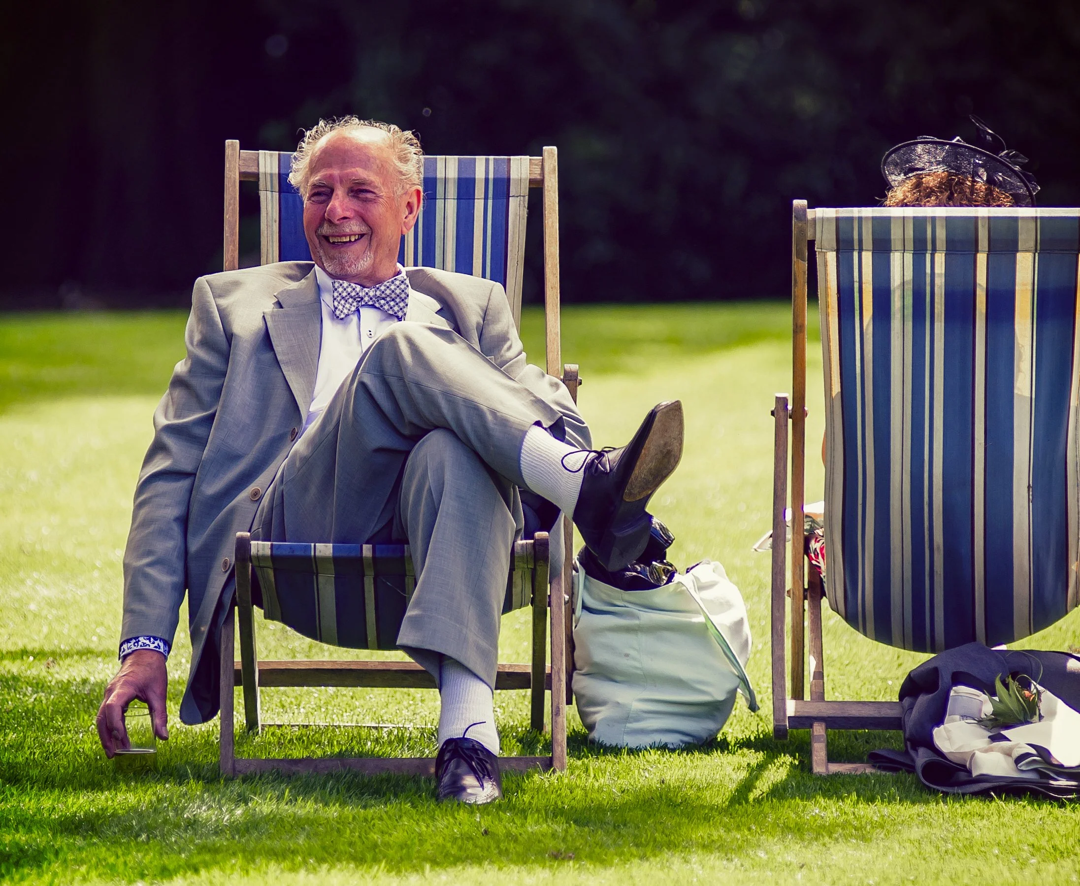 Guest relaxing in a deckchair at a summer garden party