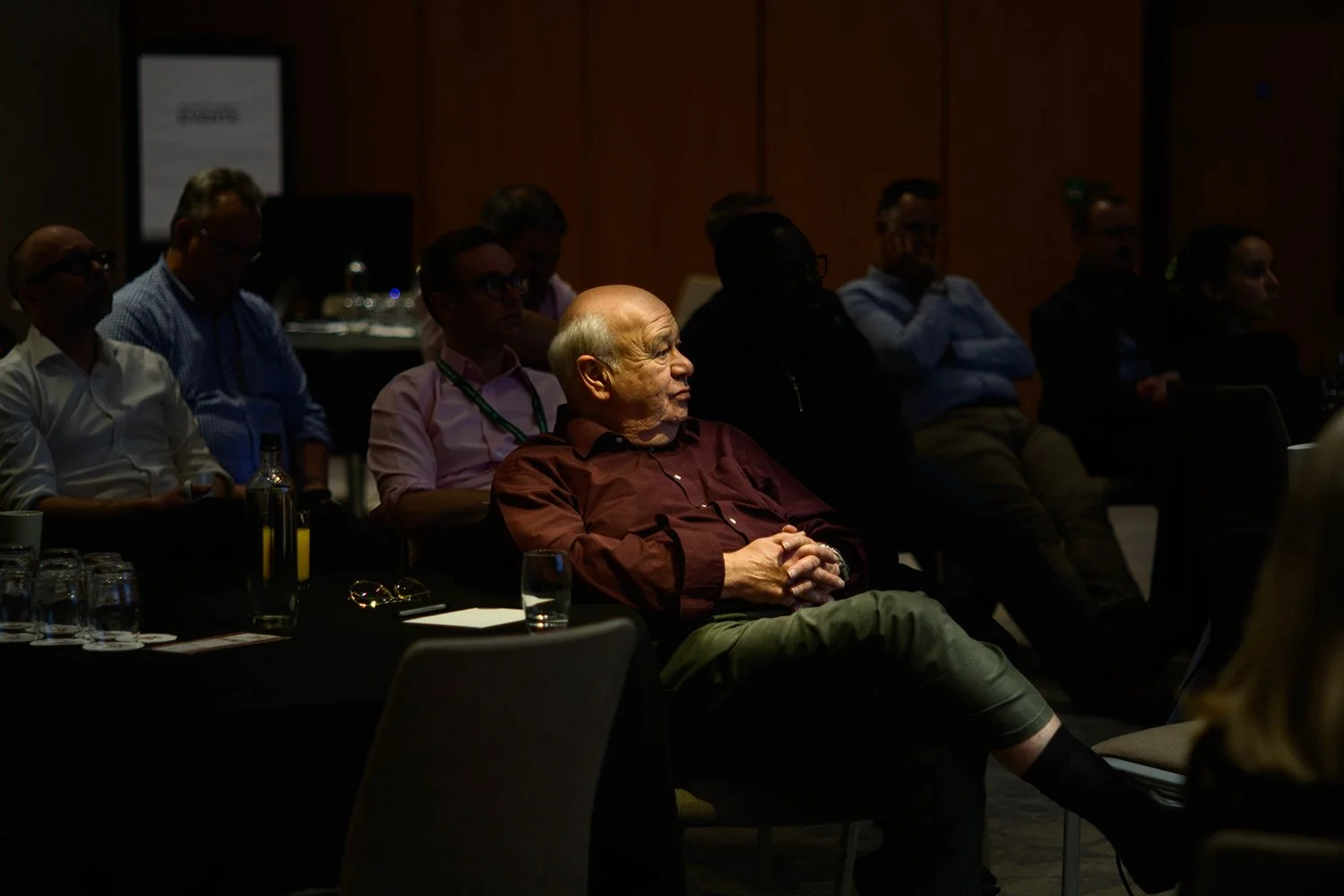 Delegate illuminated in candid image at corporate conference
