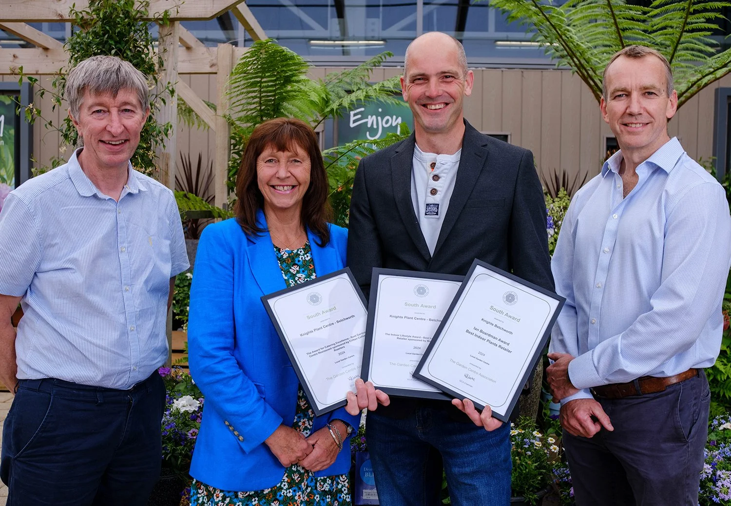 Award winners with certificates at an awards ceremony