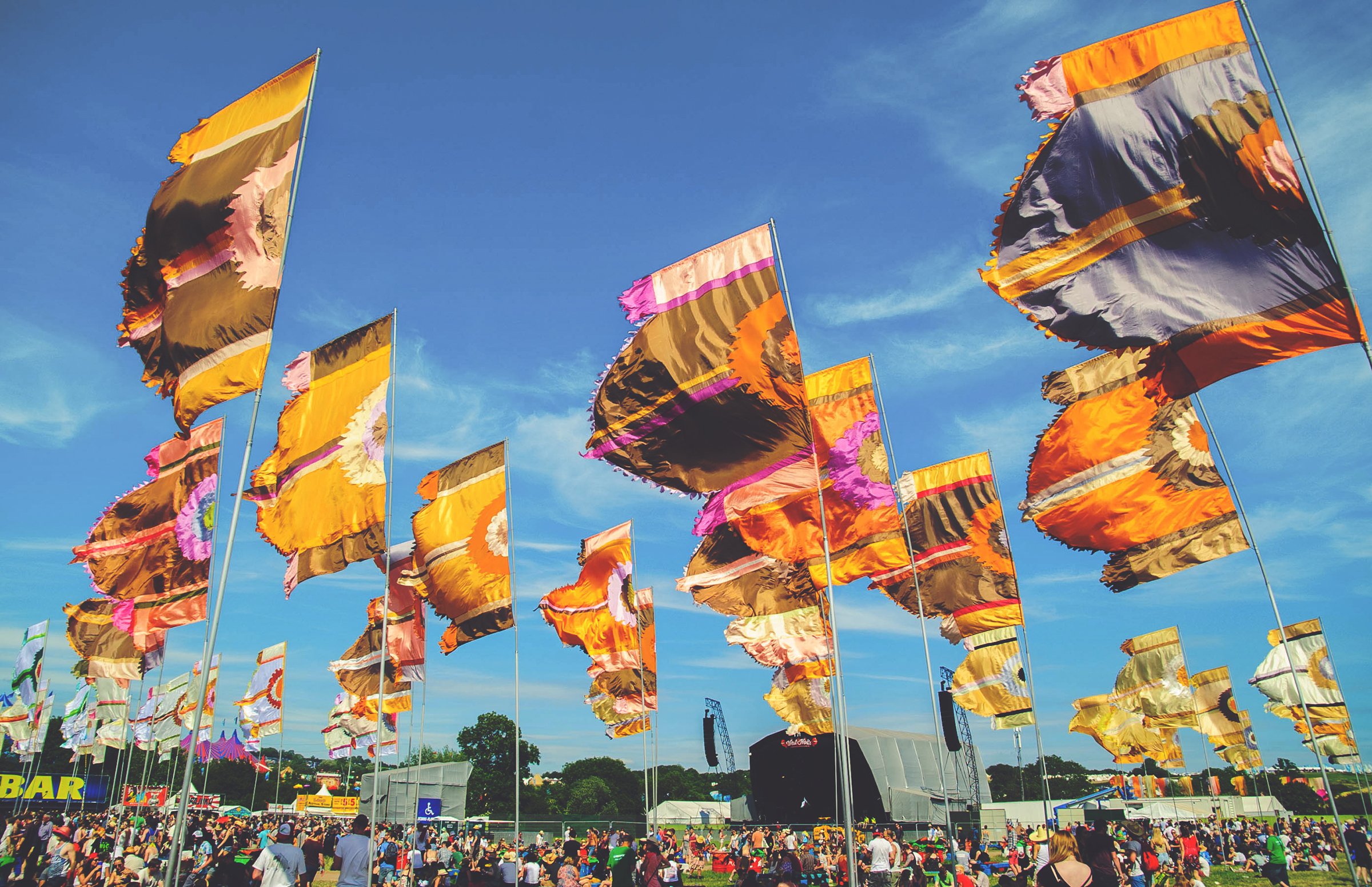 Colourful festival flags and crowd at Glastonbury
