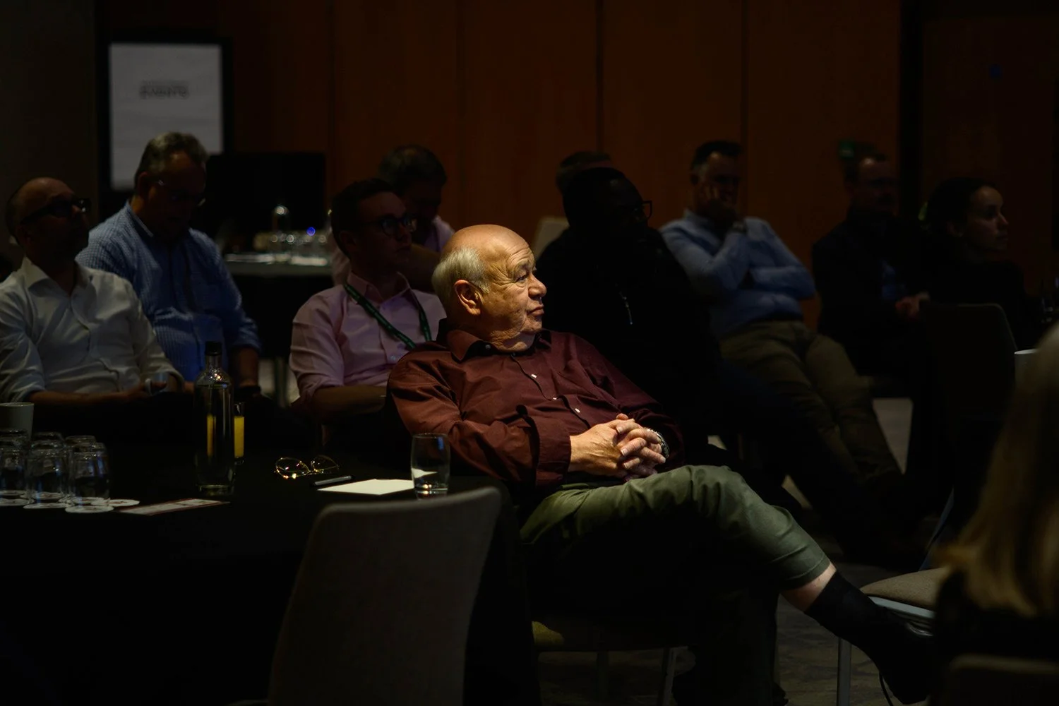 Attendee listening during a conference presentation