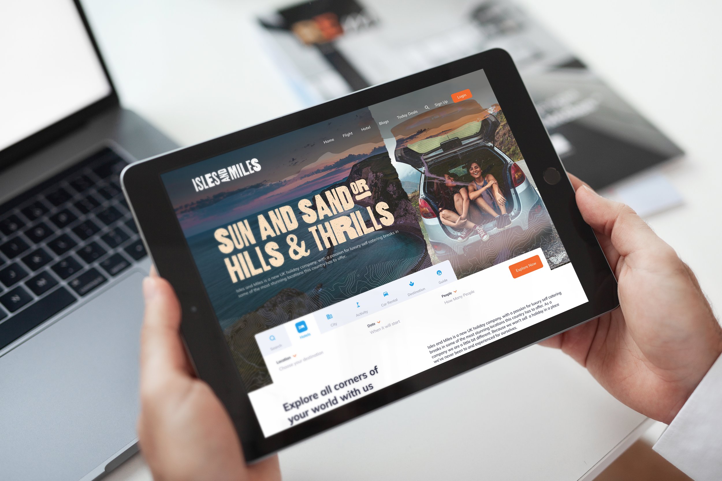 An iPad on a dark surface displaying a website for architectural design with a modern house and the words "LIVE BEAUTIFULLY".