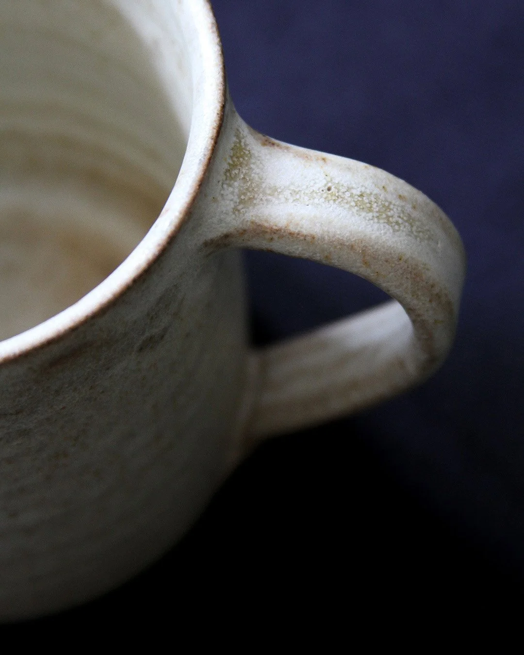 A close up detail of a mug handle showing its glassy qualities