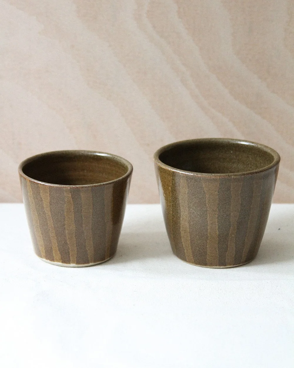 Two striped coffee cups side by side