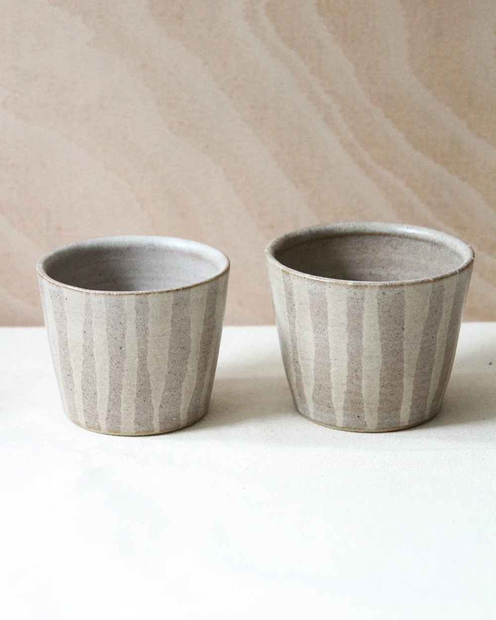 Two striped coffee cups side by side