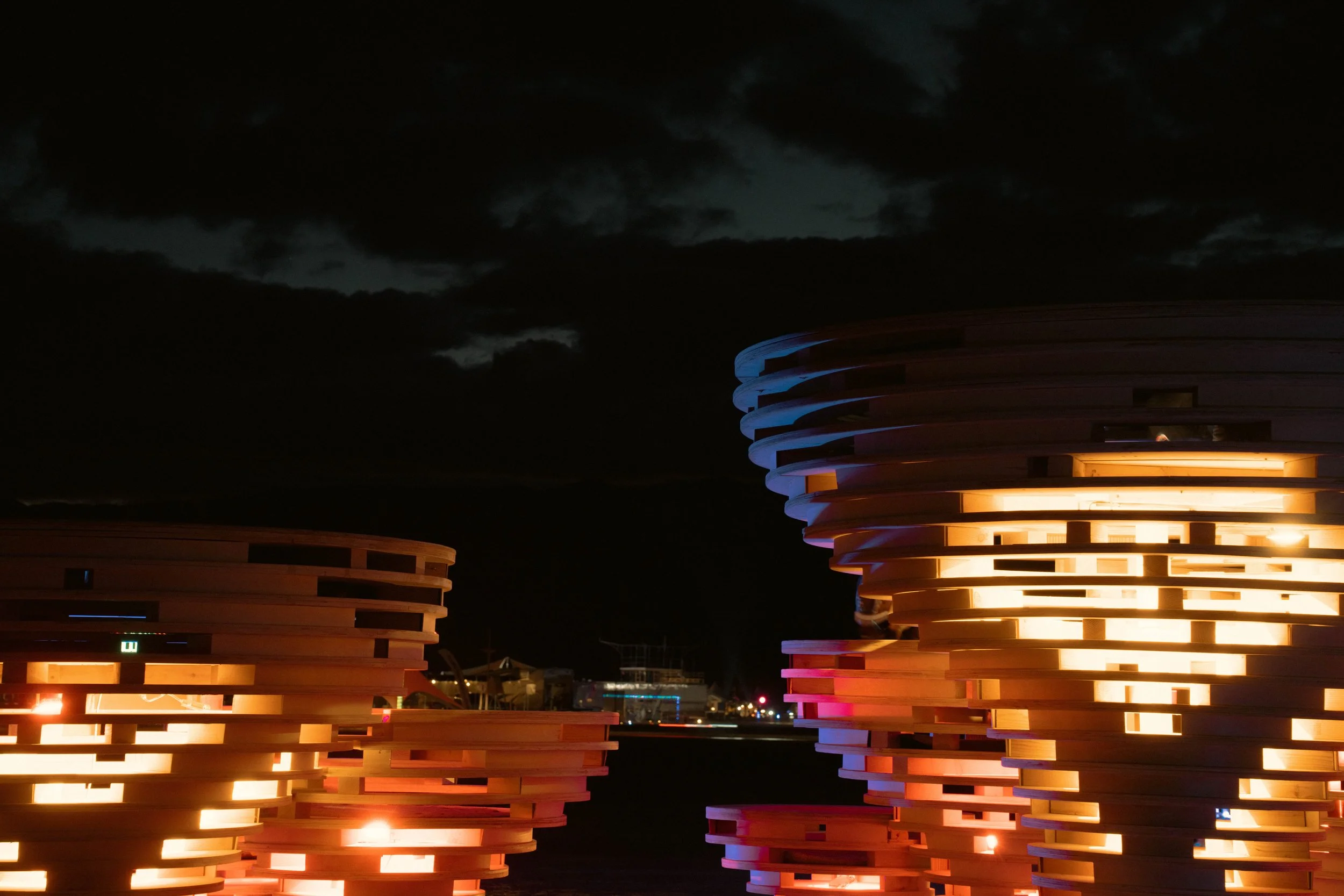 Nebula Shroom Grove by Understory Collective, for Burning Man 2024, photographed by Kristina Chan for Atelier et.al. — Nighttime Installation detail of lighting system inside mushroom canopy glowing purple, green, and yellow in the night