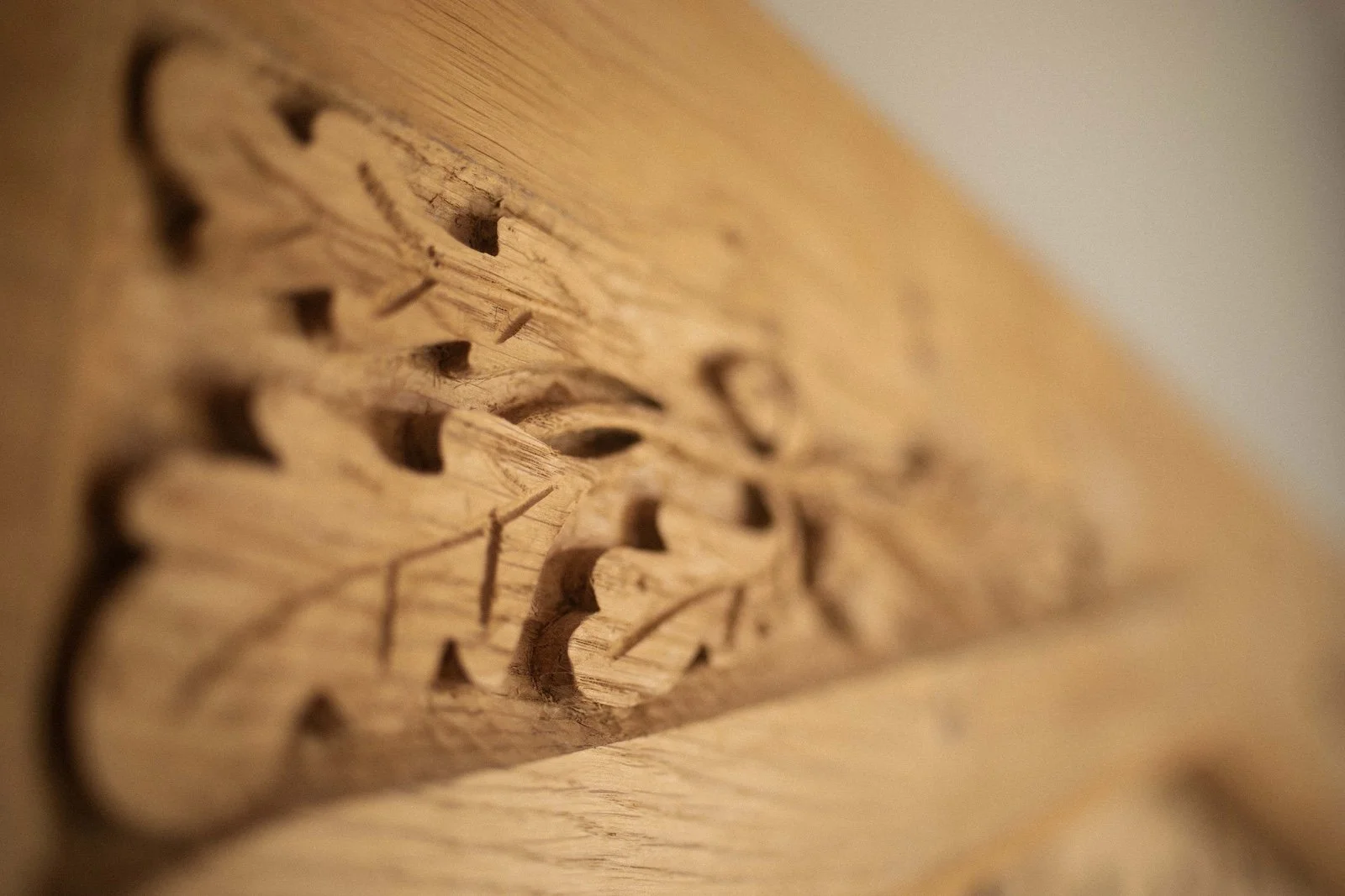 Close-up of a carved wooden piece with intricate patterns and designs.