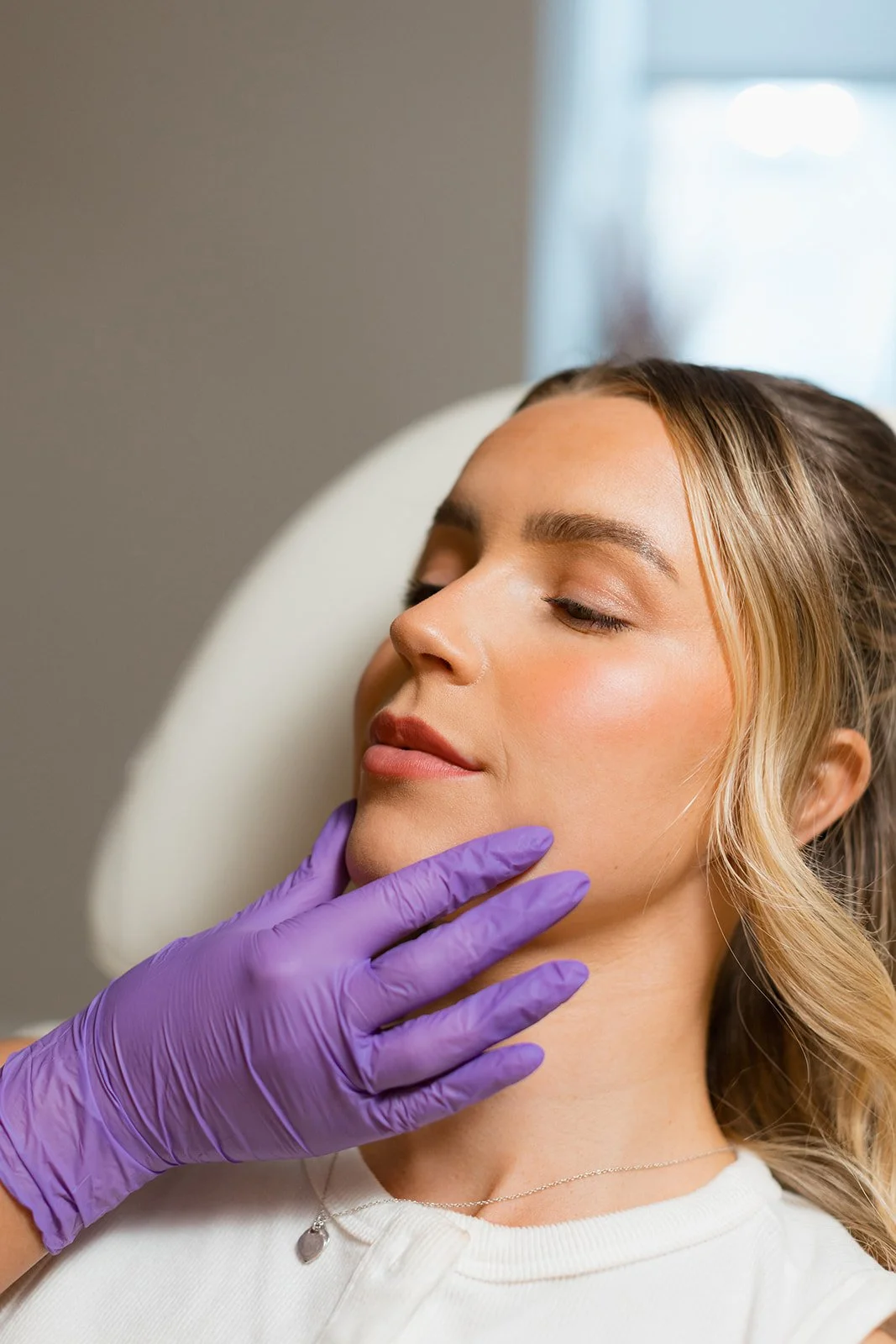 Clinician touching the face of a client, clinician is wearing sterile gloves