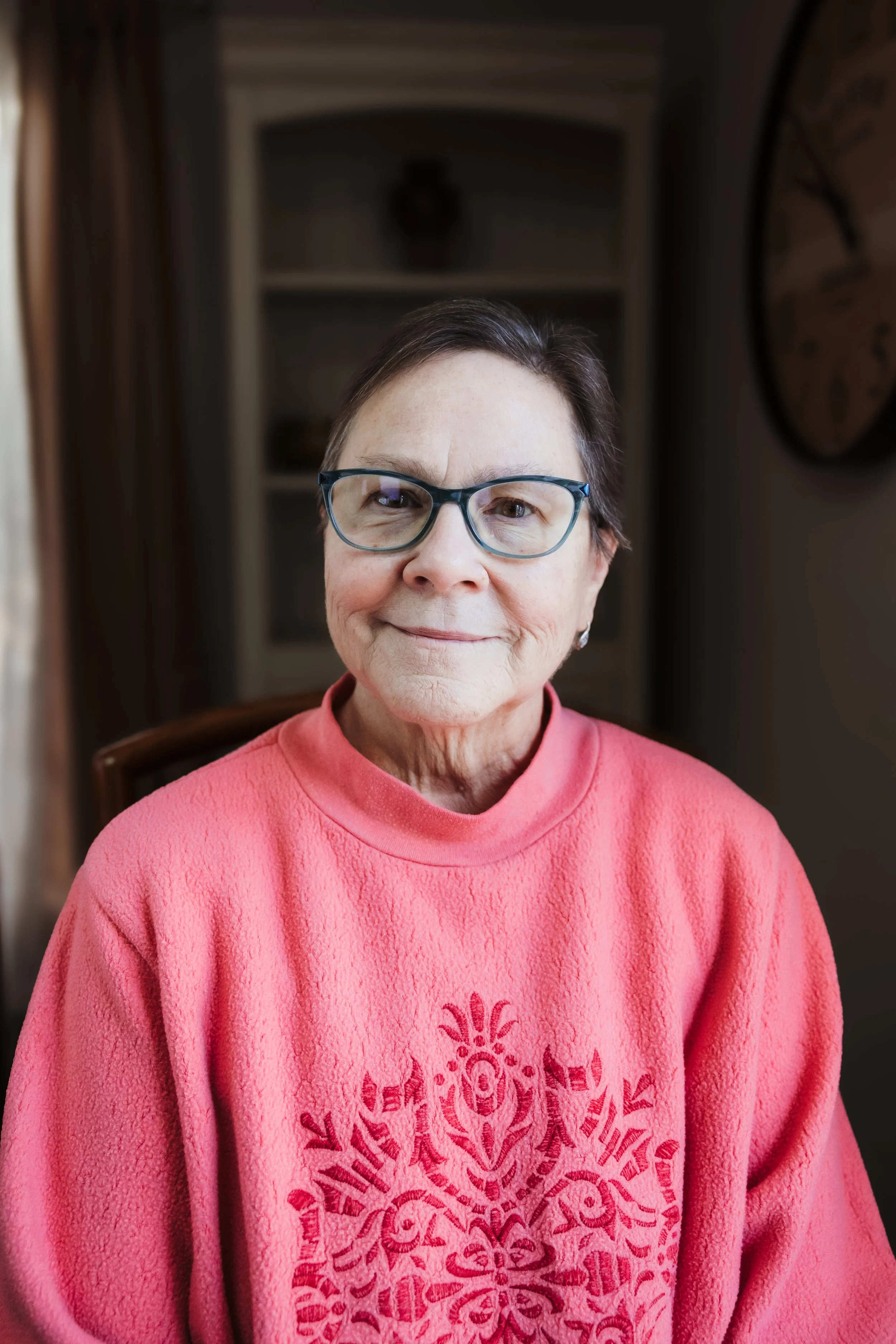 Nighttime landscape with a river in the foreground, trees along the riverbank, and a star-filled sky with the Milky Way galaxy and shooting stars overhead.