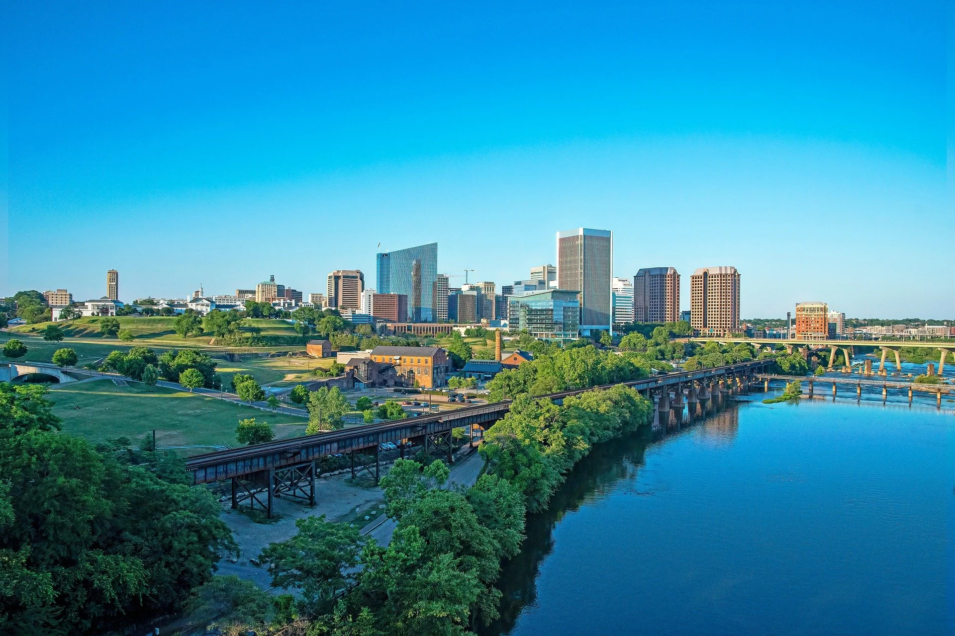 Aerial view of Richmond, Virginia, skyline along the James River with bridges, parks, and downtown buildings