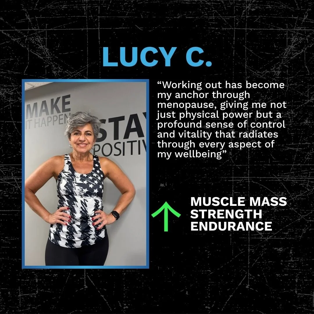 A woman with short gray hair wearing a black and white patterned athletic top, standing with hands on hips inside a fitness center with motivational words on the wall.