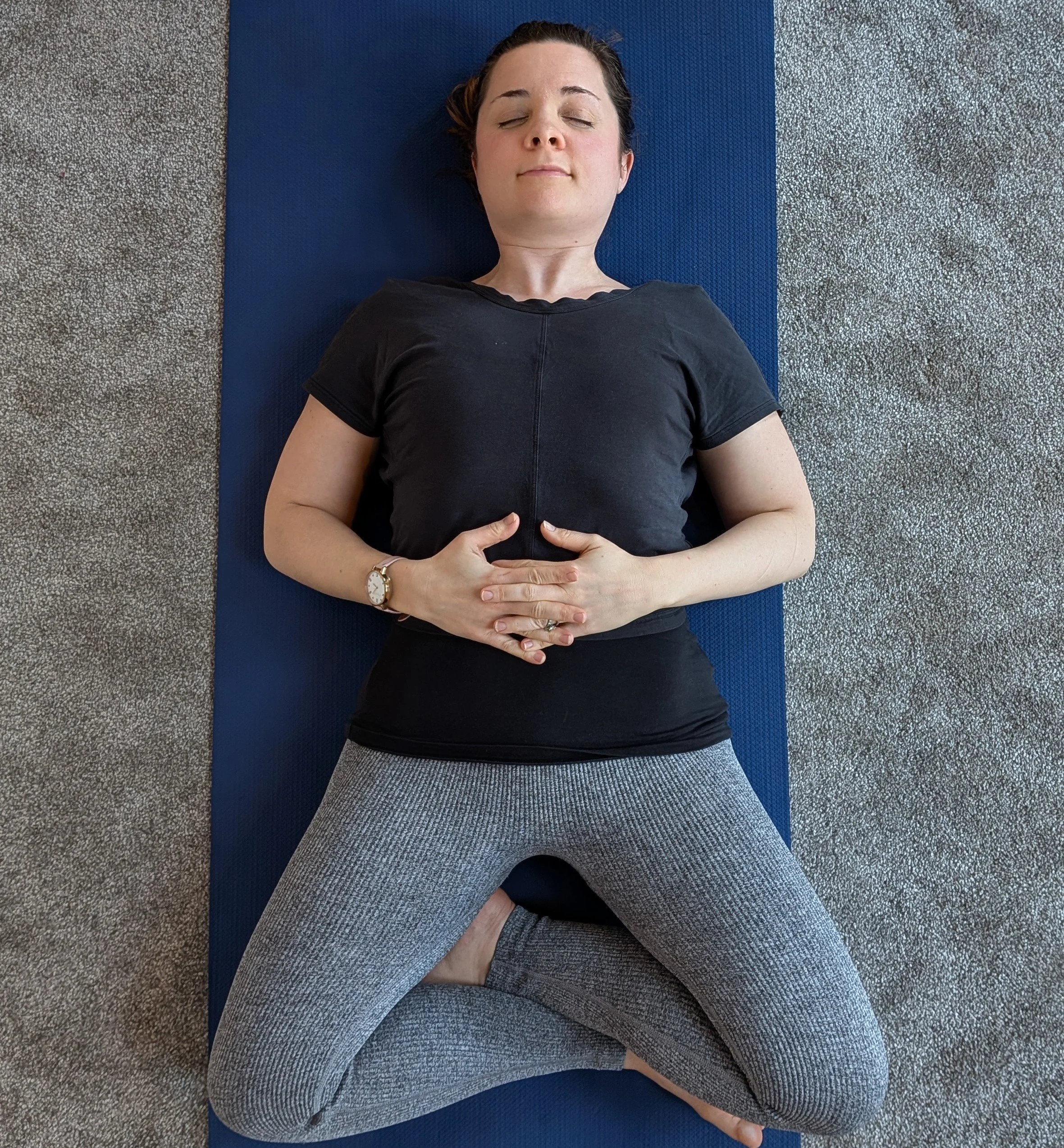 Ellen lying down in relaxed butterfly pose