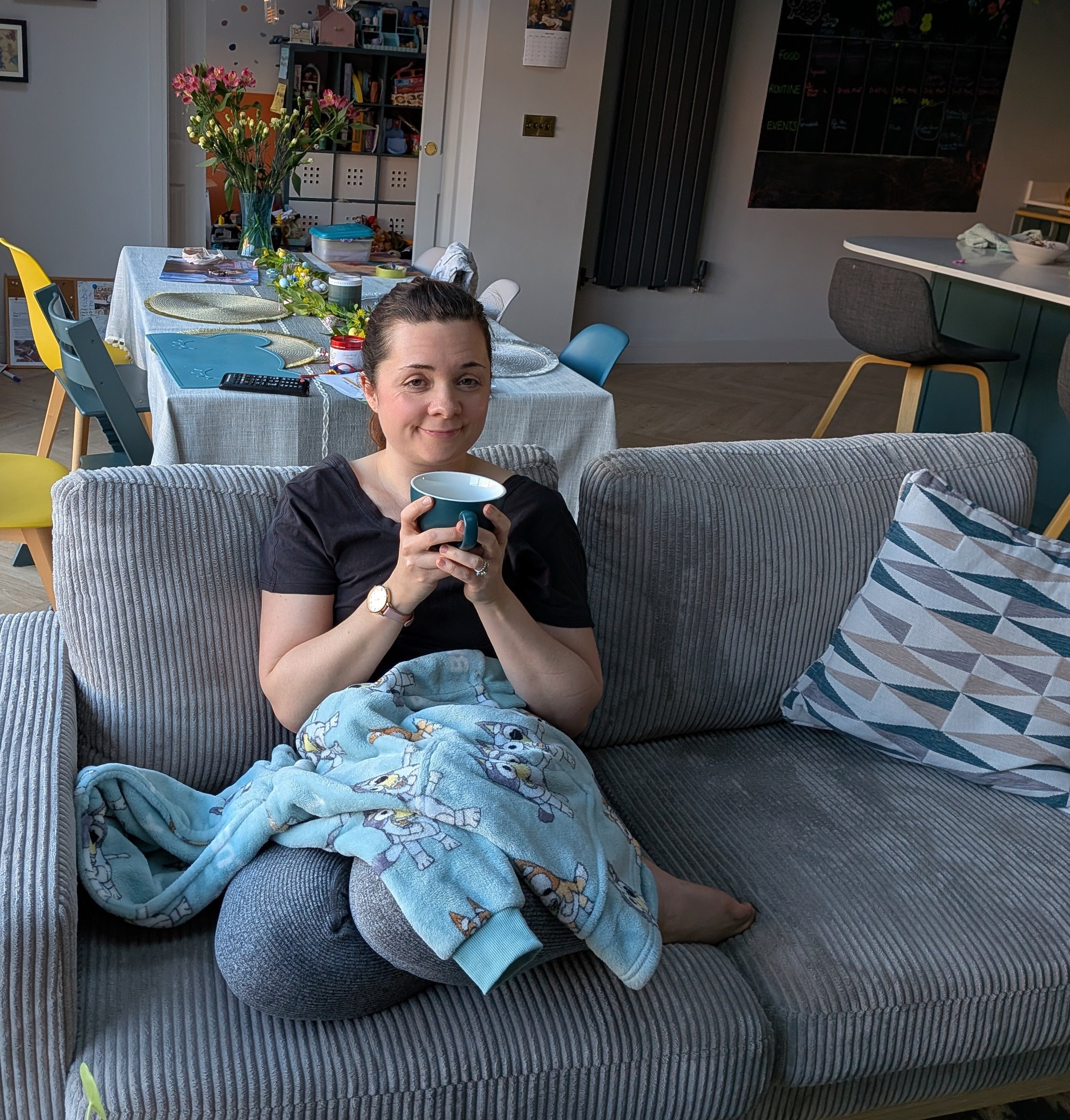 Ellen sat with warm tea, smiling