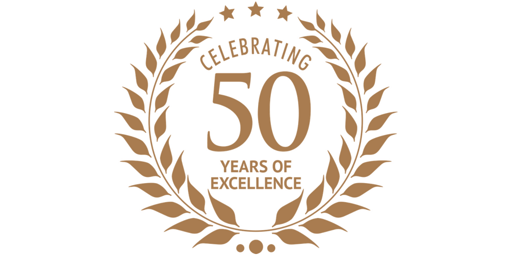A gold laurel wreath surrounding the text 'Celebrating 50 Years of Excellence' with three stars above it, on a white background.