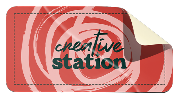 A paper sticker with a red and white swirl background and the words 'creative station' in green and black text.
