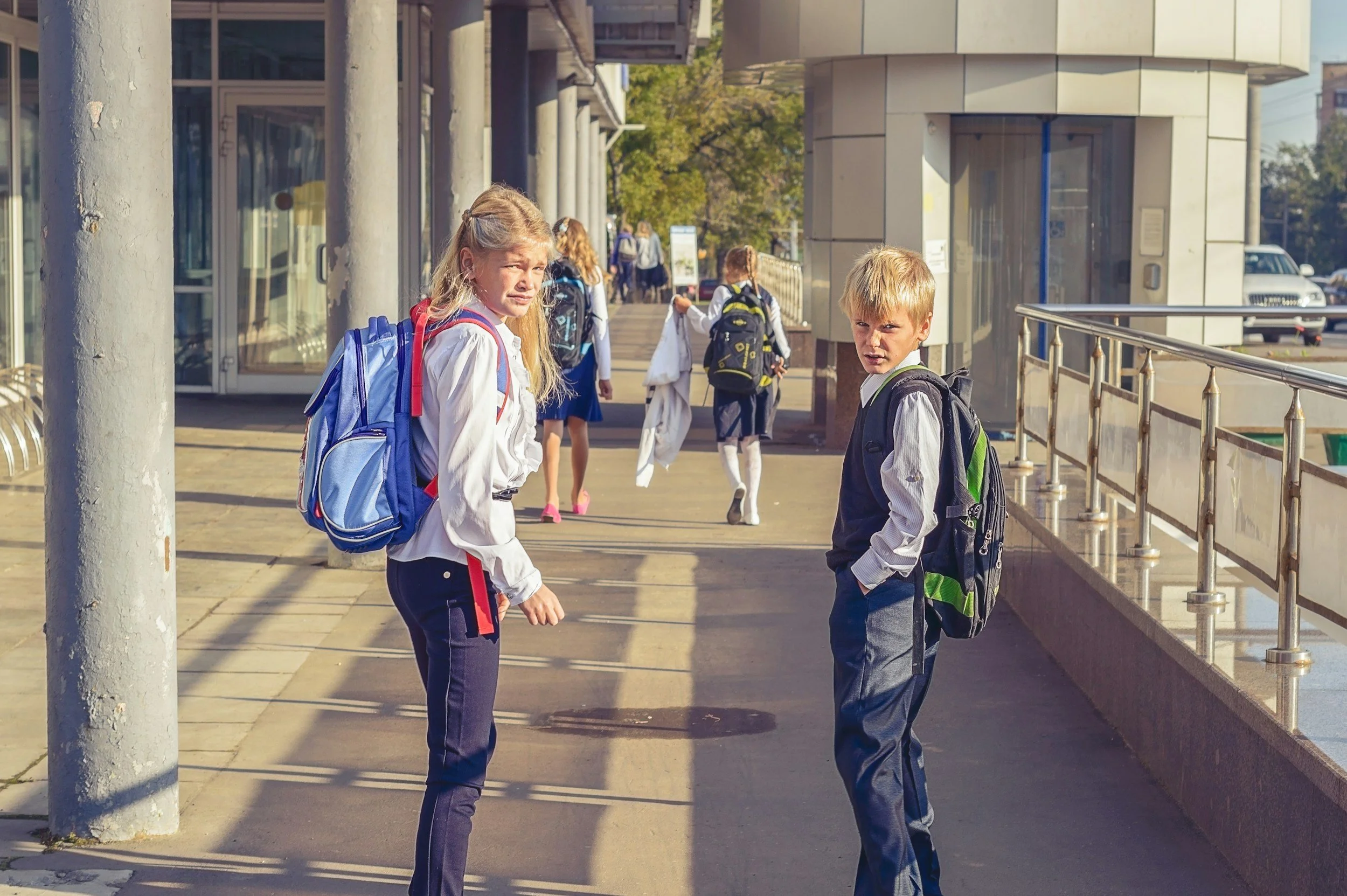 Children and families walking on a city street during the school run