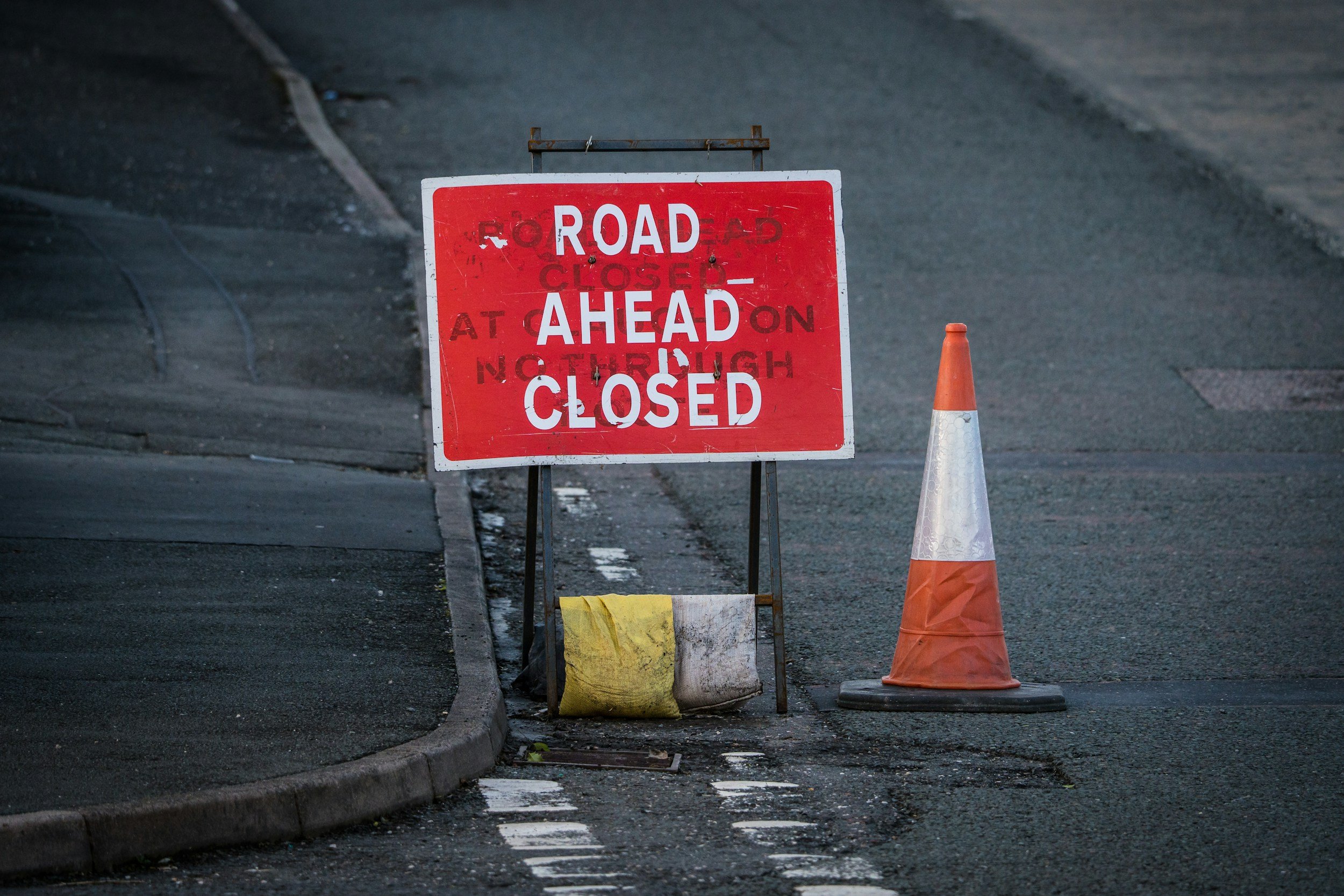 A Road Ahead Closed sign and traffic cone on a closed road, marking the phased closure of Western Road in Brighton and Hove