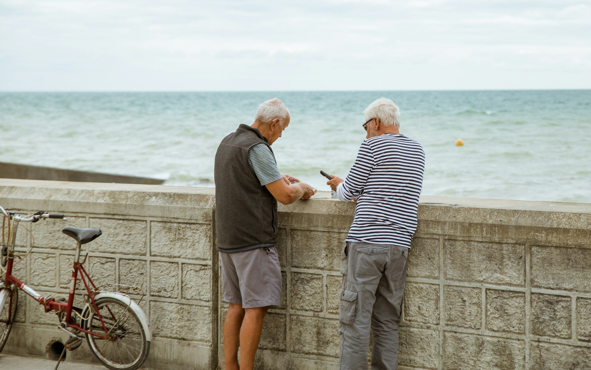 Two older men by the seafront, representing Brighton and Hove residents whose council pension fund is under scrutiny over West Bank investments