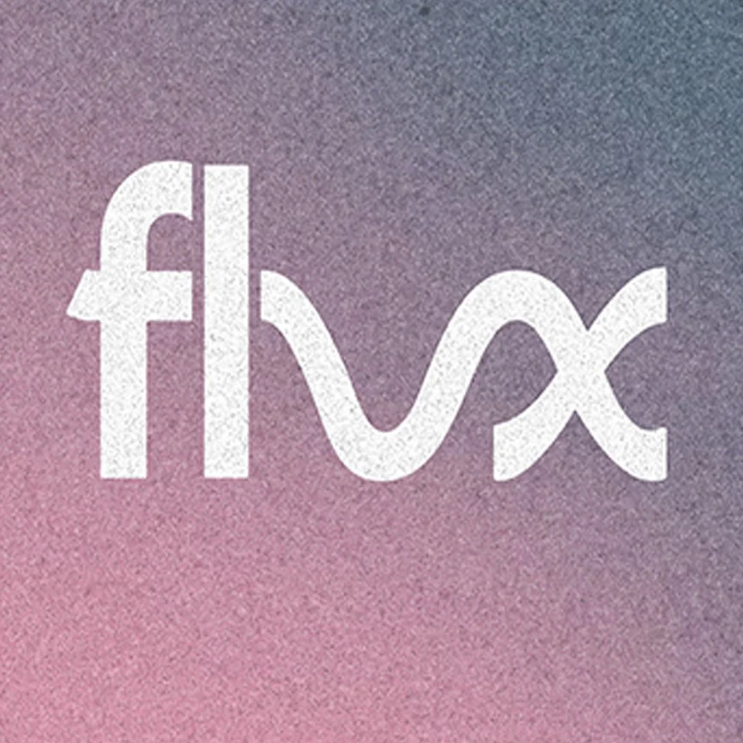 A softly lit purple flower against a dark background for Flux