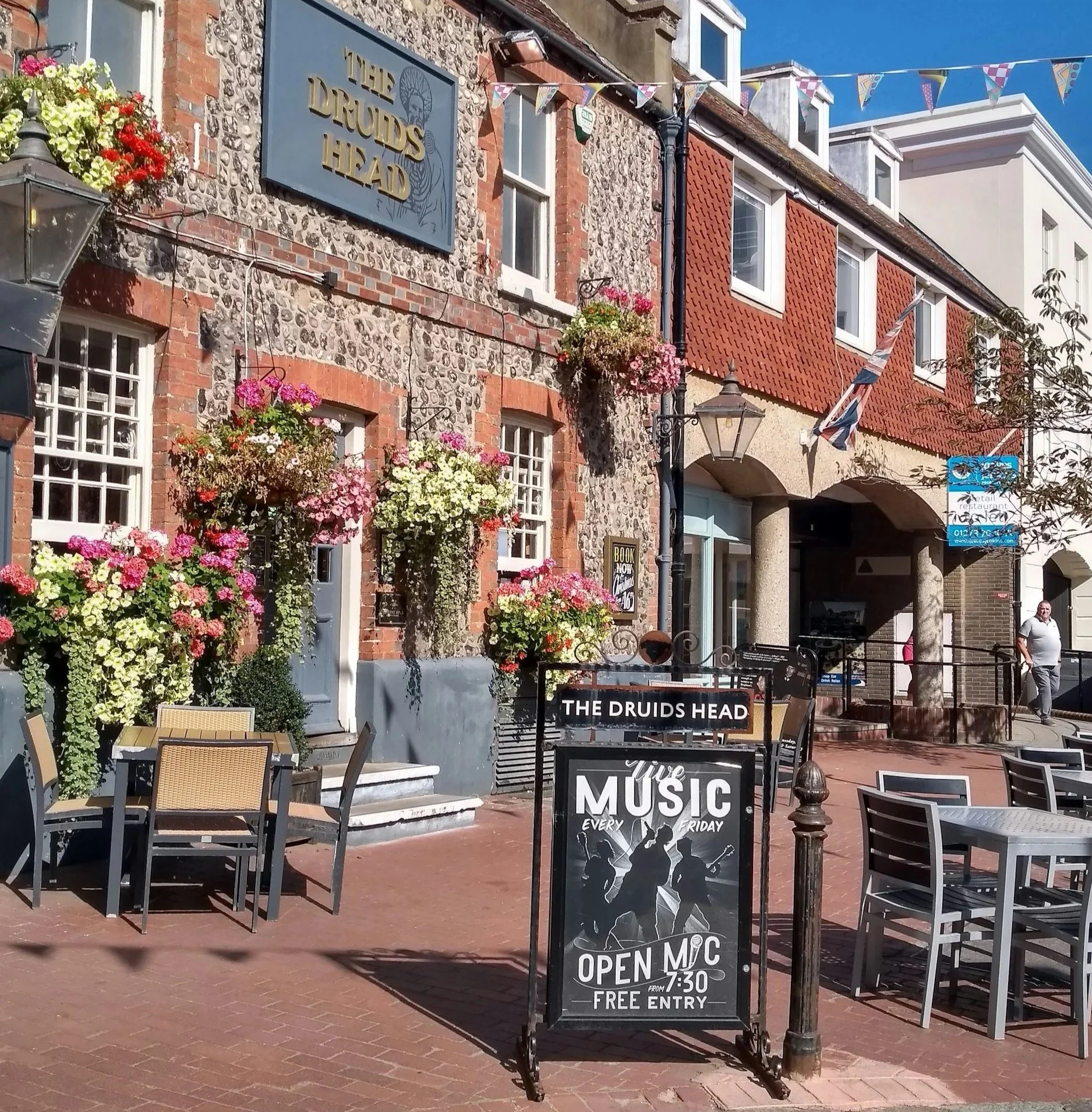The Druids Head pub in Brighton with outdoor seating and flower displays
