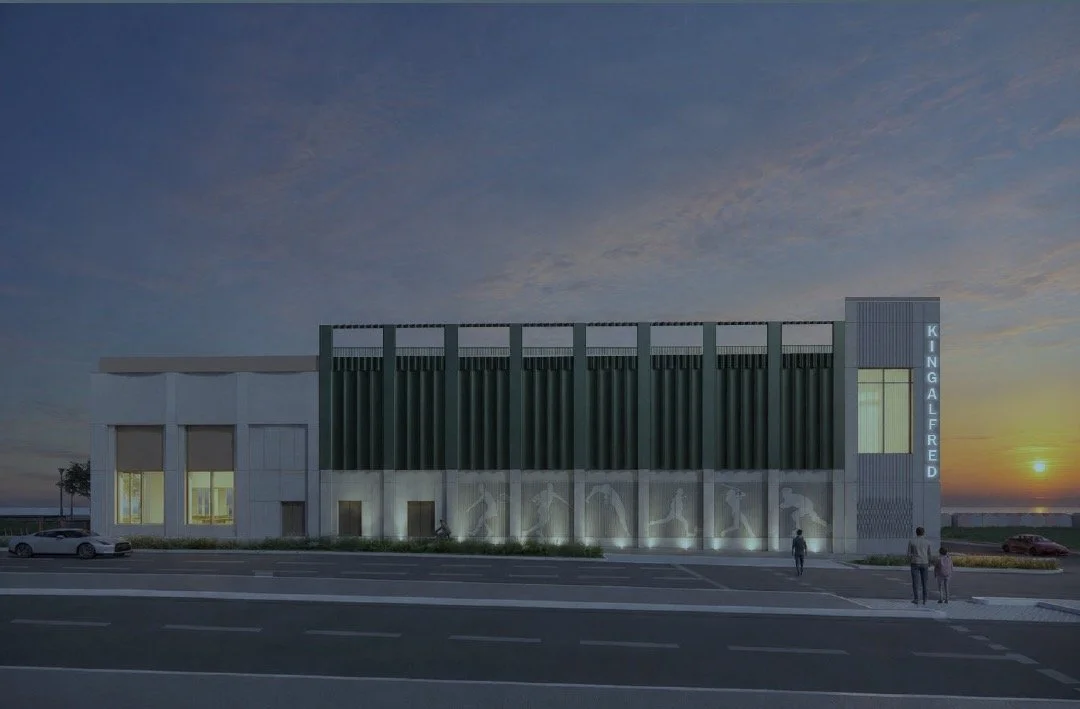 Side view of the proposed new King Alfred Leisure Centre at sunset with the King Alfred tower sign lit