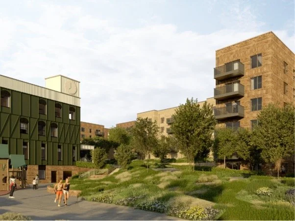 Architect's image looking towards the community hub and housing development in Flintfield Drive, with a green clock-tower building, brick apartment blocks and landscaped green space