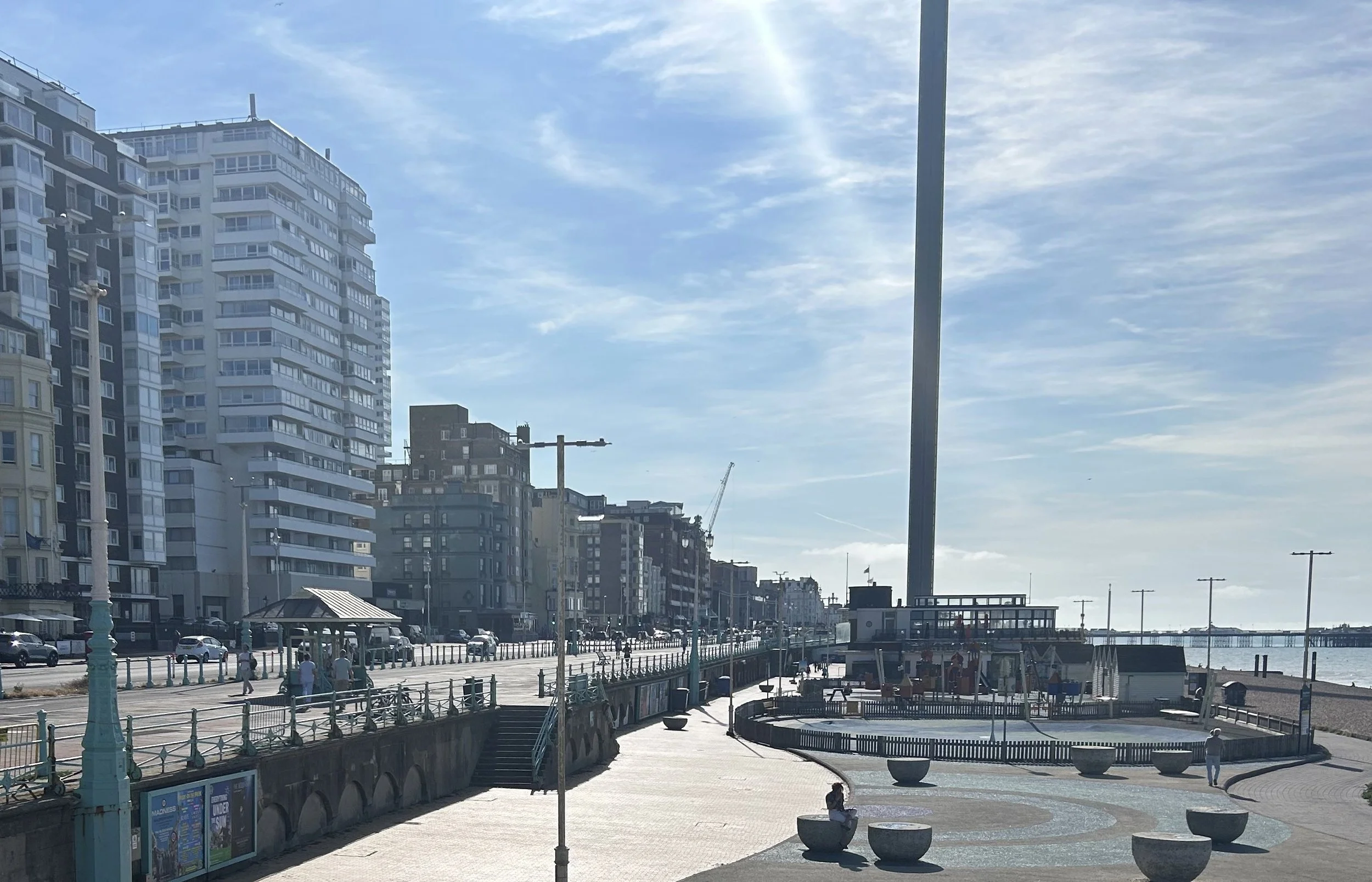View along Brighton seafront near King's Road with seafront apartments and the arches below