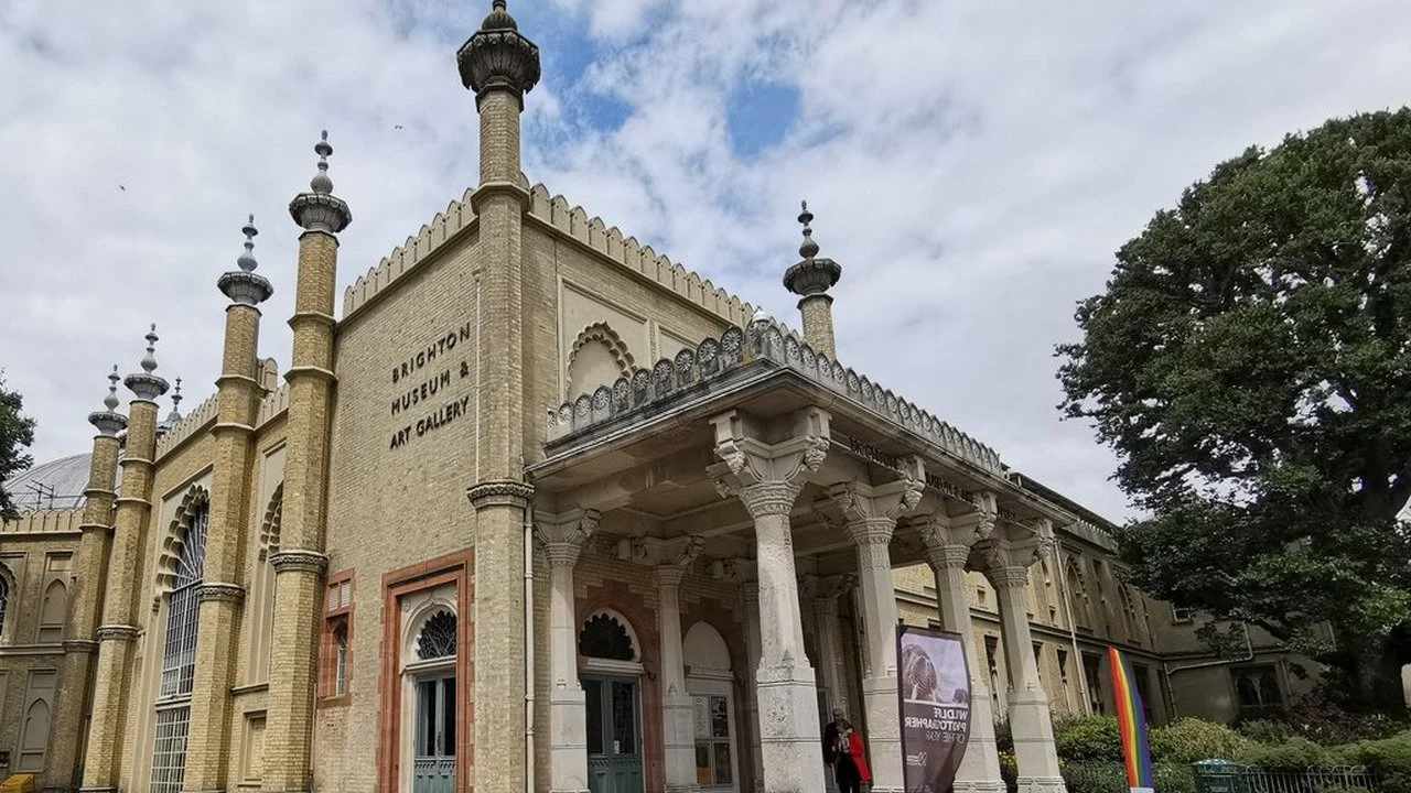 The entrance to Brighton Museum and Art Gallery in Pavilion Gardens, a yellow brick building with minarets and a covered porch