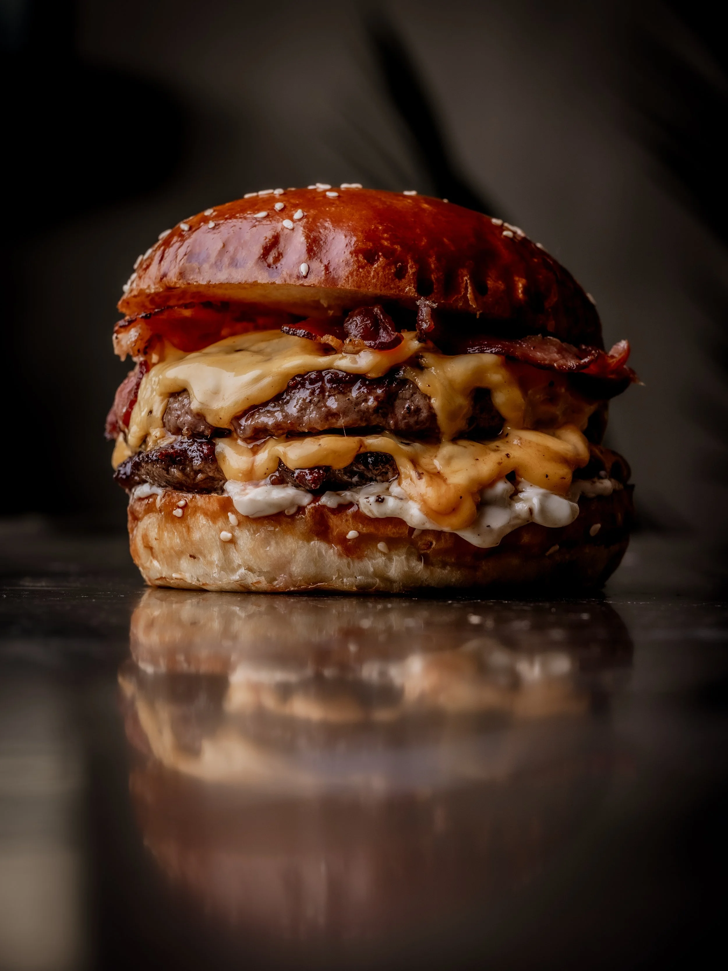 Signature Burger & Beyond cheeseburger with melted cheese and bacon at the restaurant's Brighton location