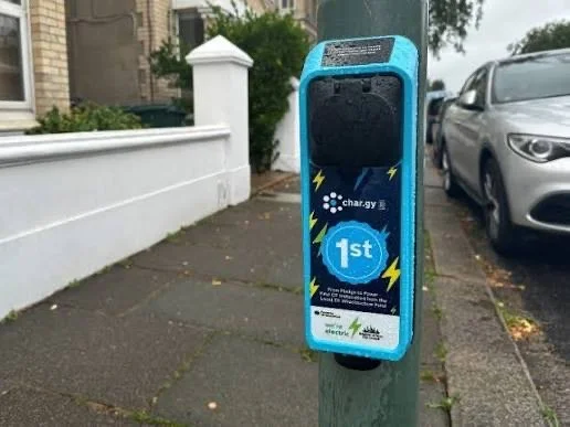 Close-up of a char.gy chargepoint marked "1st" on a lamp post in Brighton & Hove