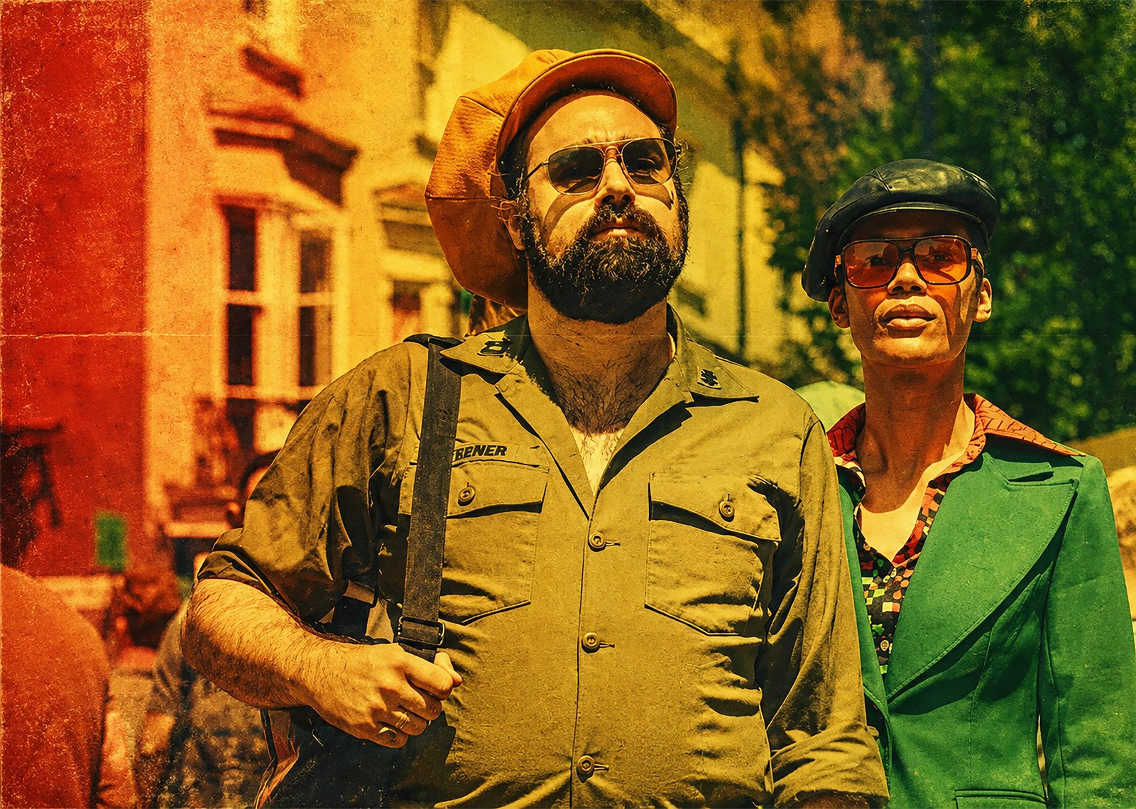 Frankie Dread and Tara Gold of The Tribulizations in colourful outfits on a Brighton street, photographed by Gilly Photography