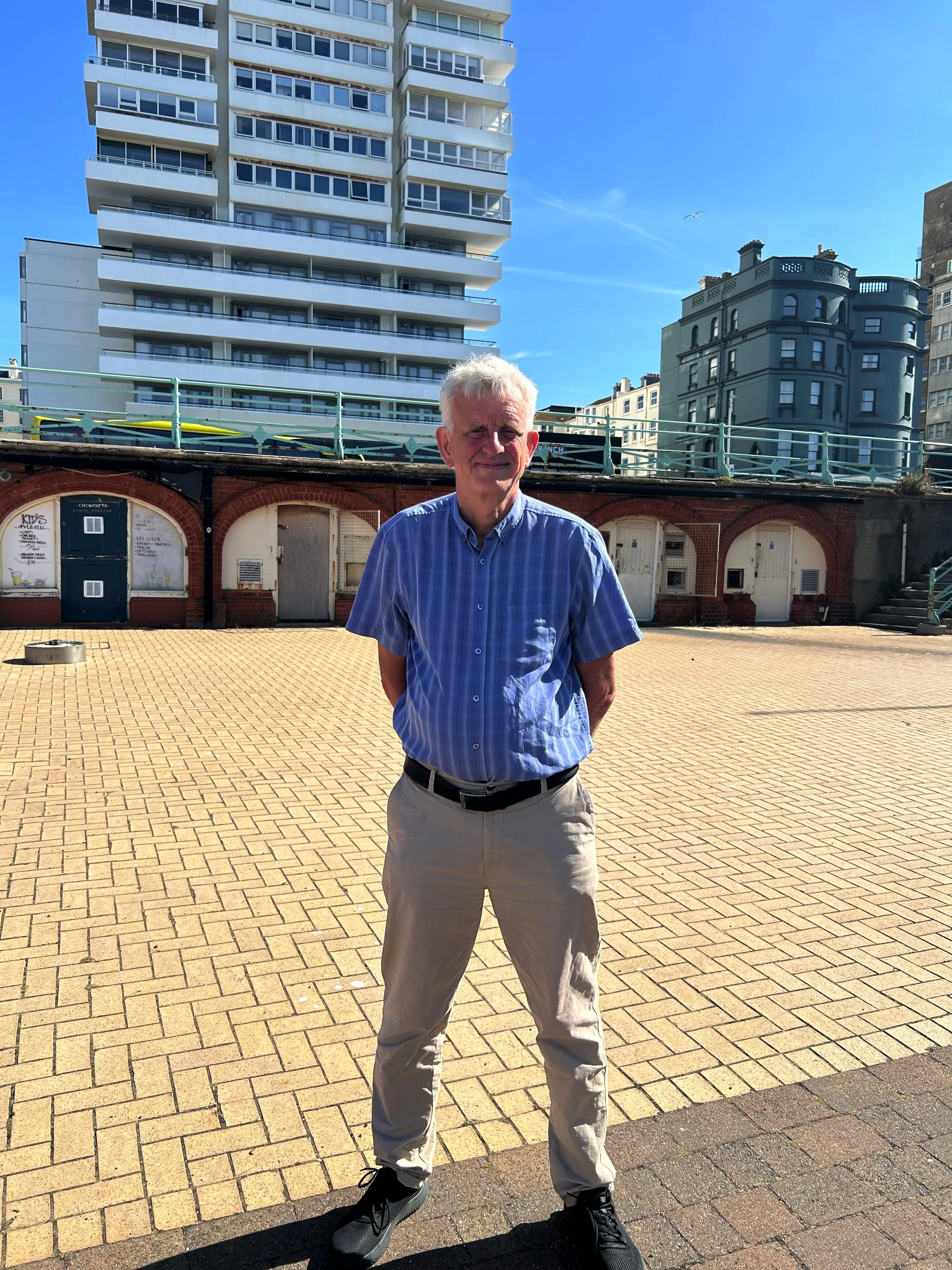 Councillor Trevor Muten, Cabinet Member for Transport and City Infrastructure, standing on Brighton seafront near the King's Road arches