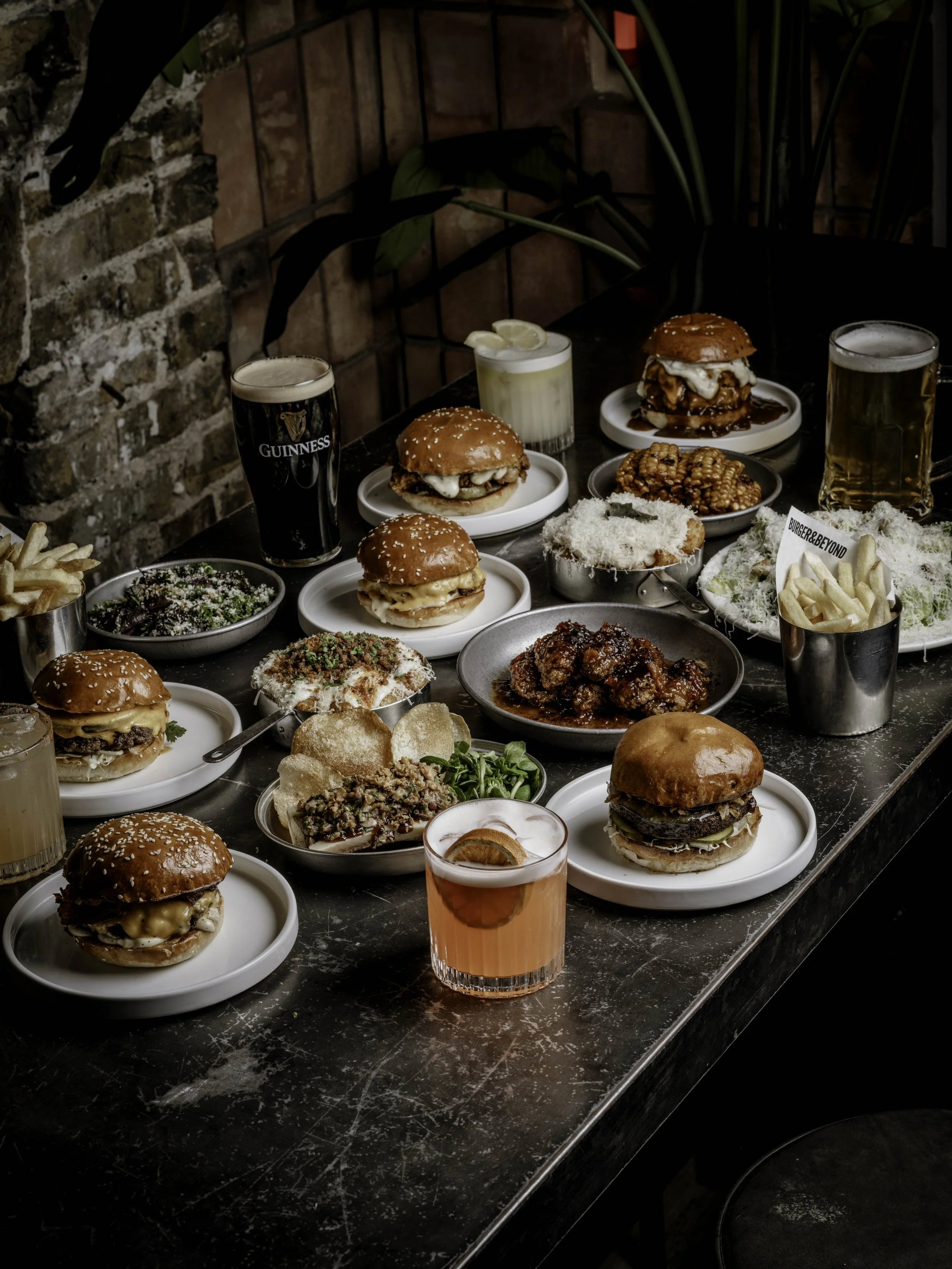 A selection of Burger & Beyond menu items including burgers, fries, chicken wings, sides and drinks at the Brighton restaurant